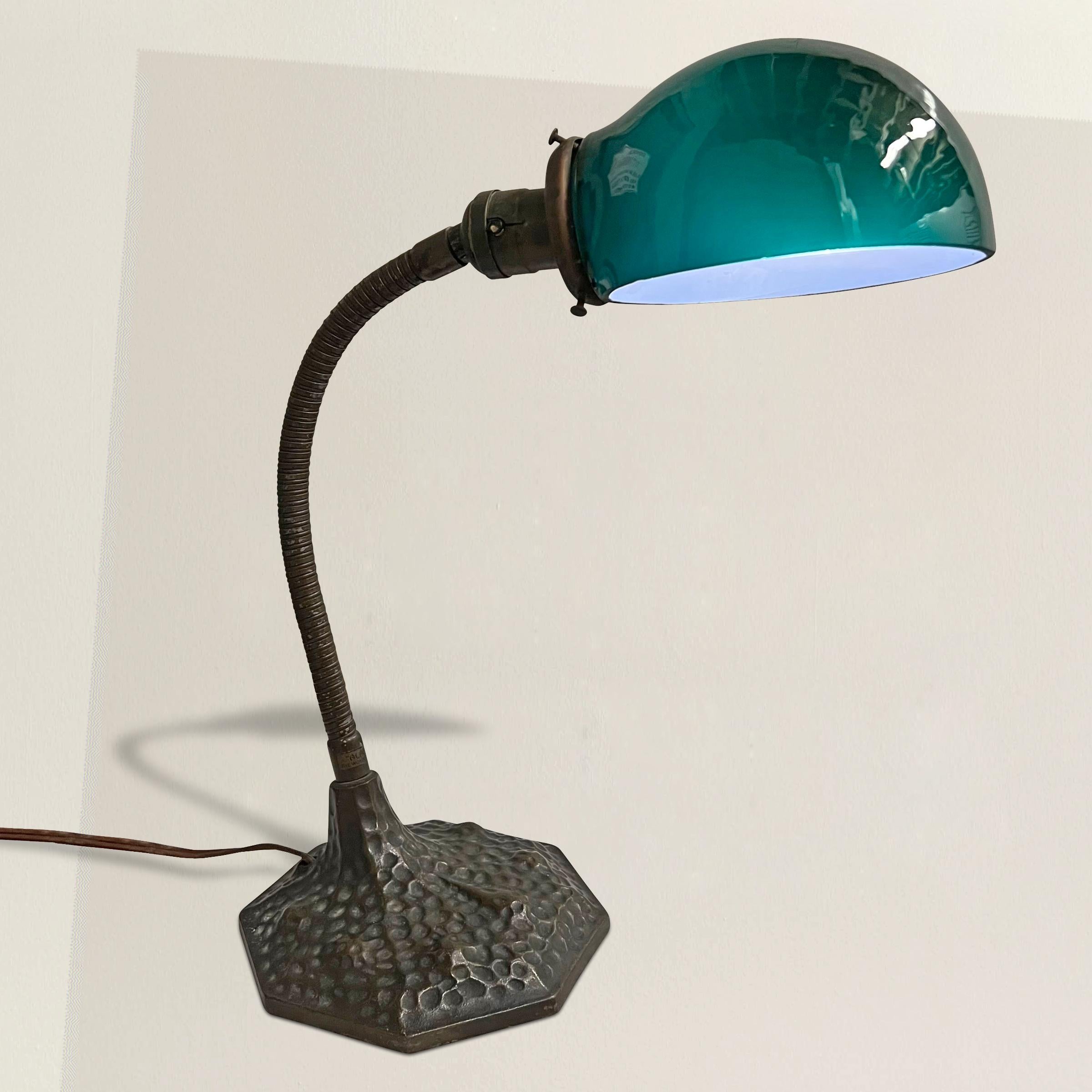 This early 20th-century American gooseneck table lamp exudes a timeless elegance that's bound to captivate any admirer of vintage lighting. Its original green glass shade adds a touch of nostalgia and sophistication to the piece, casting a warm and