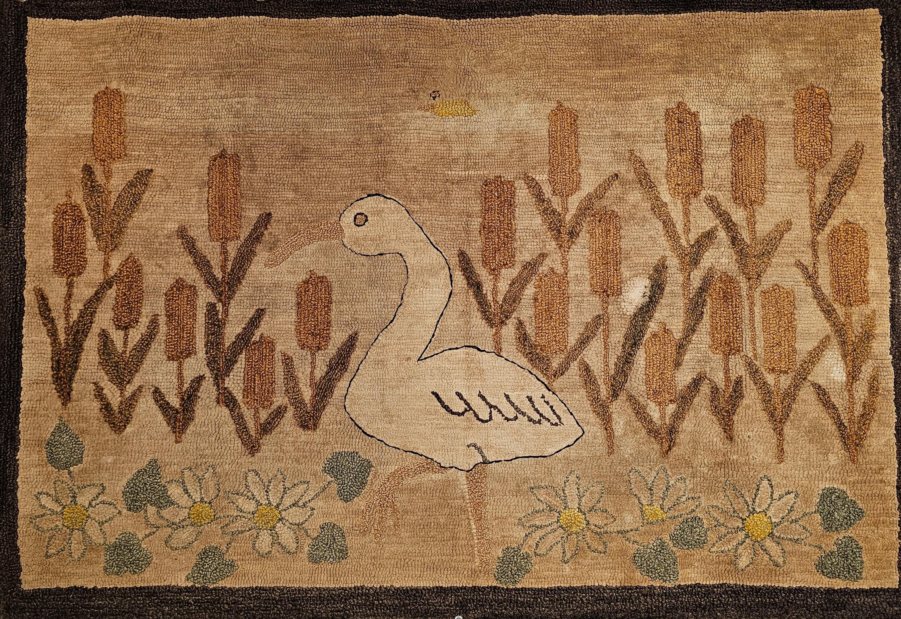 Early 20th Century hand hooked rug in a wonderful bird and flowers design in earth tone color pattern.  The rug has one of the most delightful designs we have seen in vintage American hand hooked rugs.  We are intrigued with the novelty and the