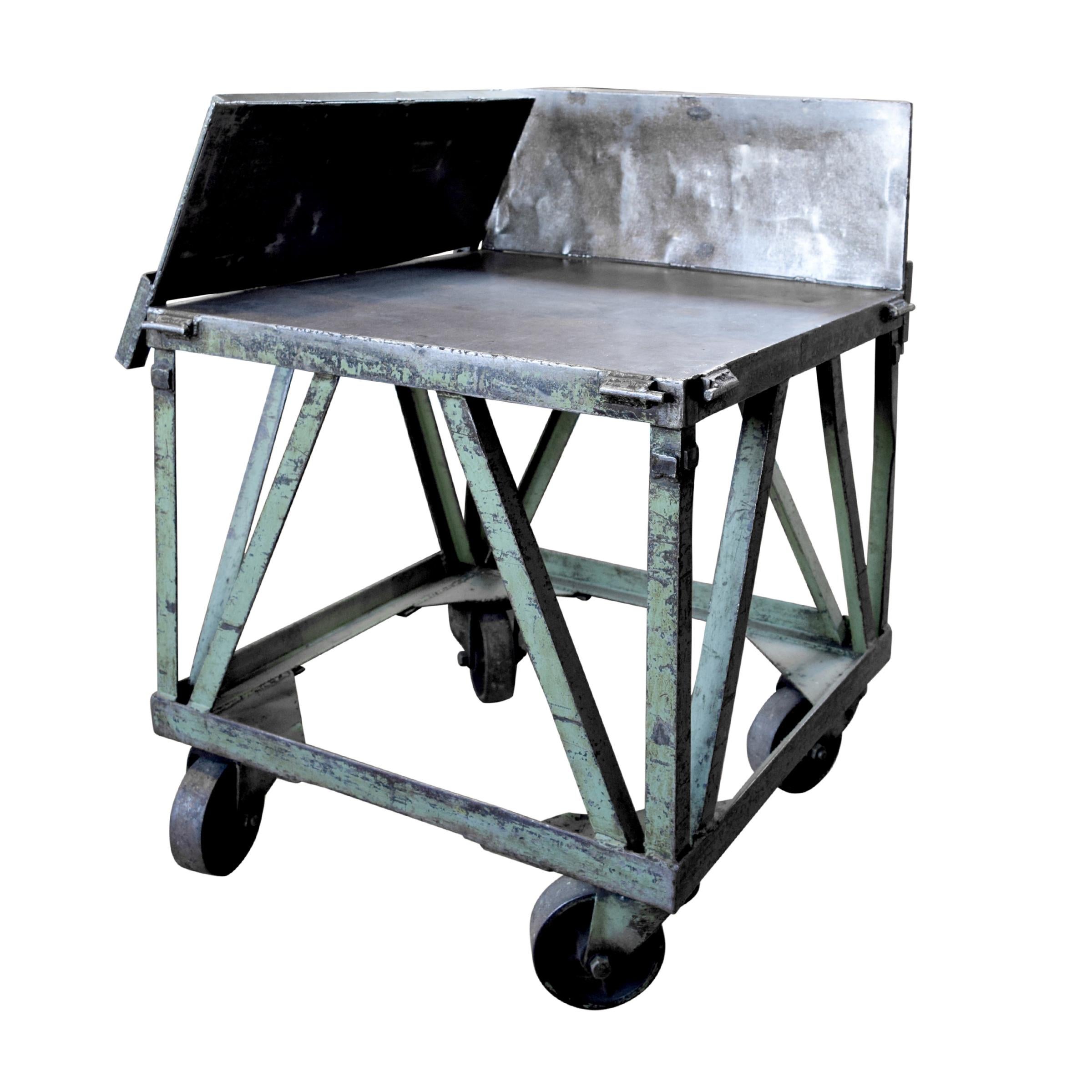 An early 20th century American industrial cart from a print shop with four flip up sides and large casters.