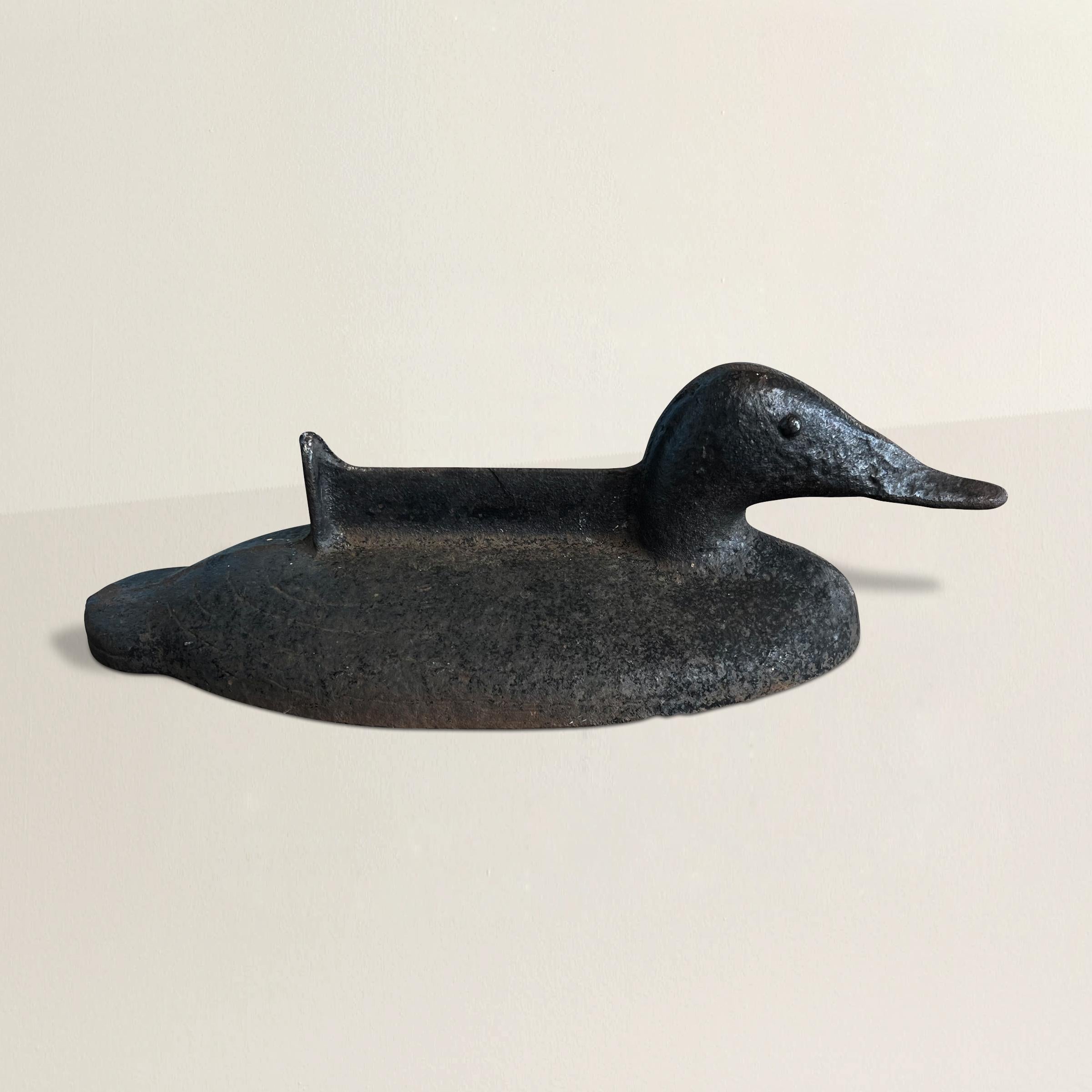 This early 20th-century American solid cast iron mallard duck boot scrape is a multifunctional piece that encapsulates both practicality and rustic charm. Initially designed as a boot scrape, this heavy and durable duck-shaped ornament was