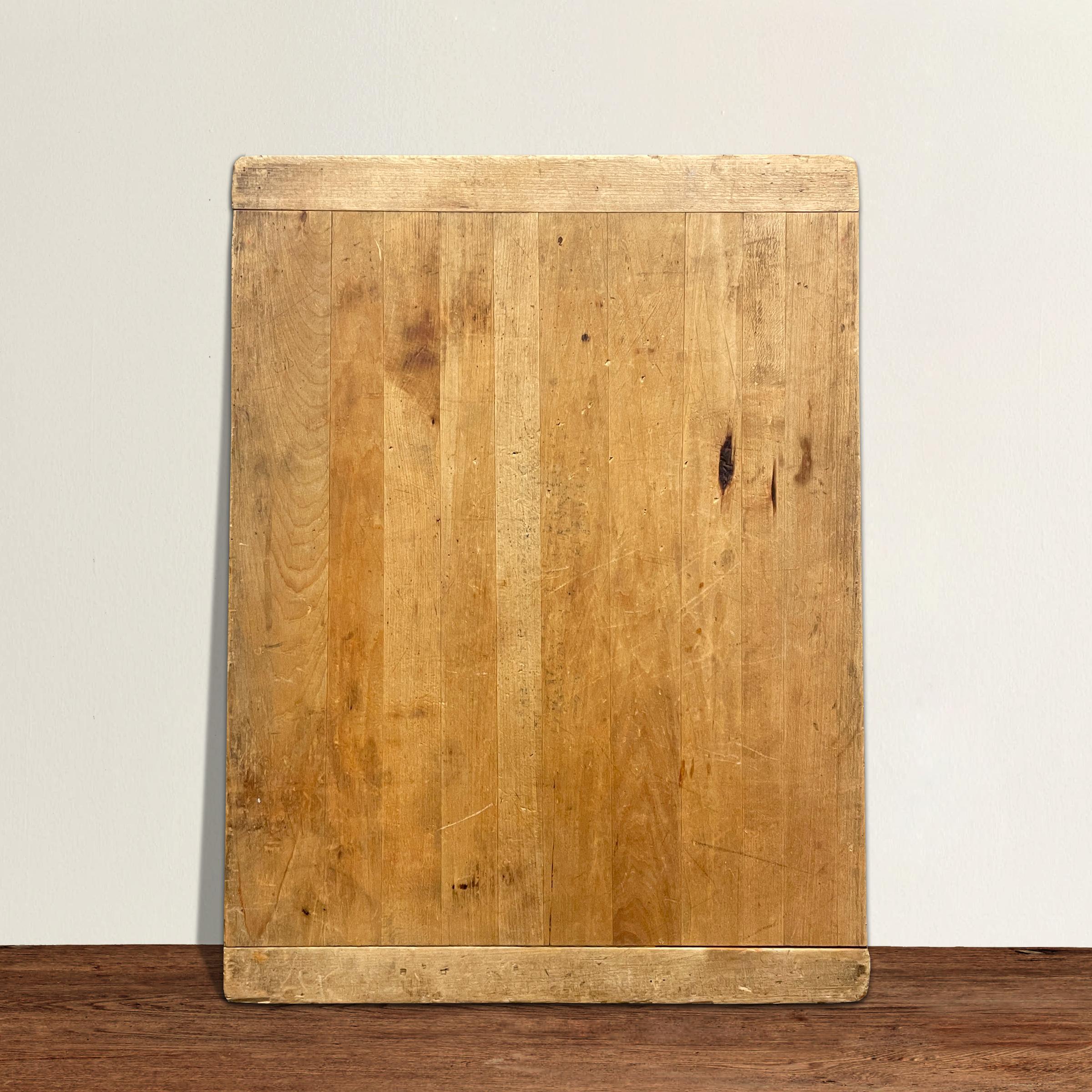 A charming early 20th century American maple breadboard with a wonderful golden patina. Sound and ready for another hundred years of use in your kitchen. Perfect for covering with cheese and charcuterie at your next fête, or piling high with flour
