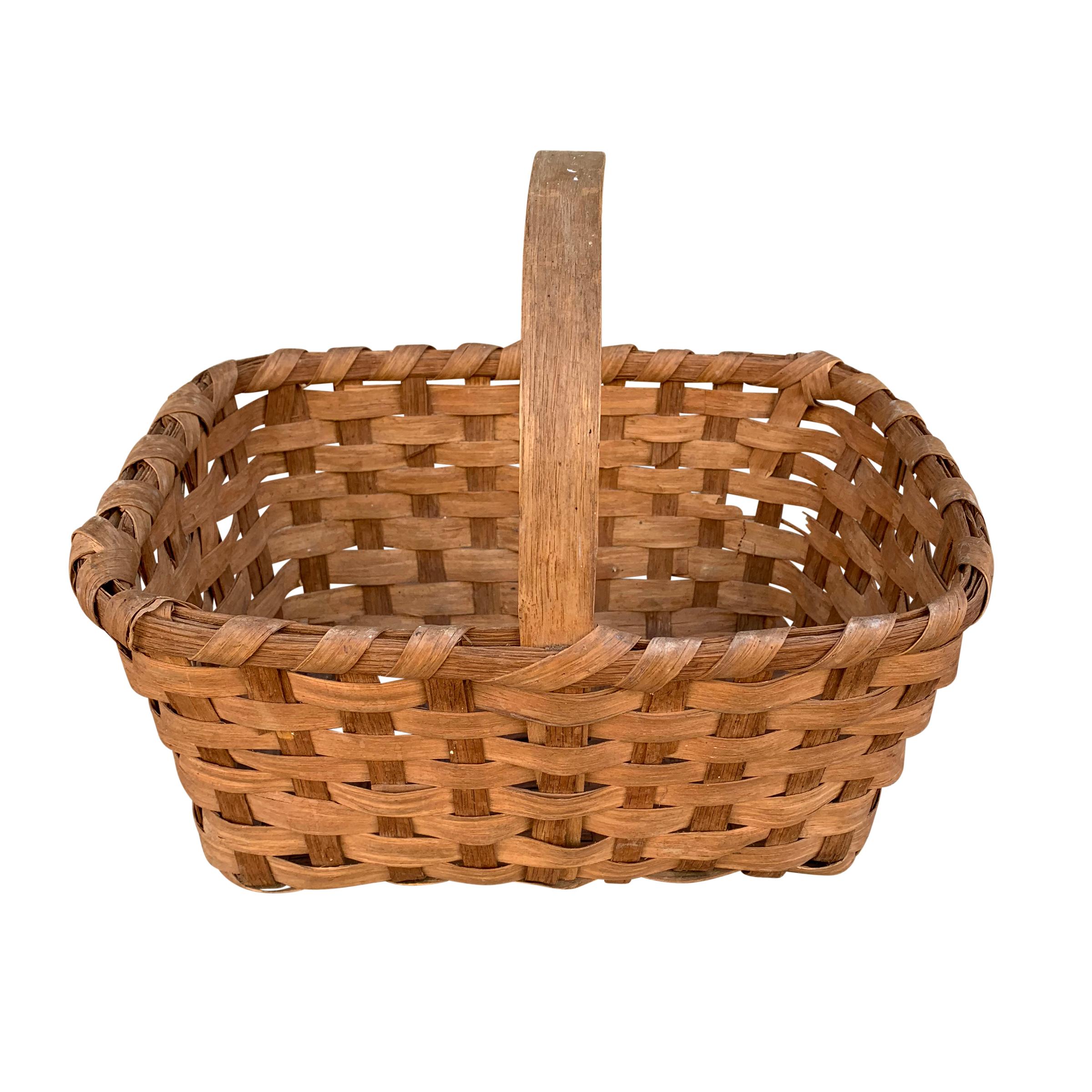 A beautiful early 20th century American oak splint gathering basket with a bentwood handle, banded rim, and wonderful patina. Gathering baskets were used to gather fruits, vegetables, flowers, and eggs on the farm.