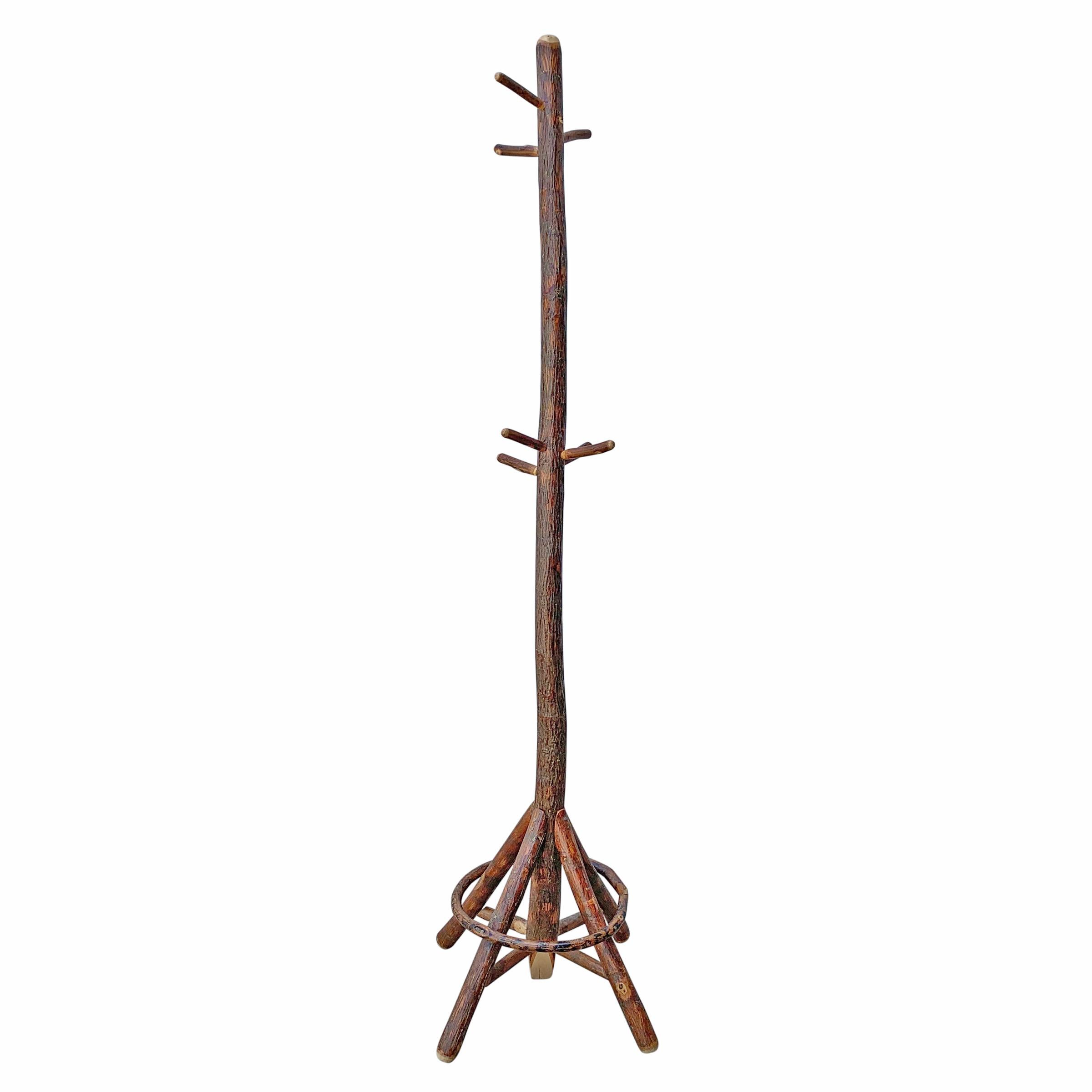 A wonderful whimsical early 20th century American Old Hickory hall tree with seven pegs for hanging coats, hats or umbrellas.