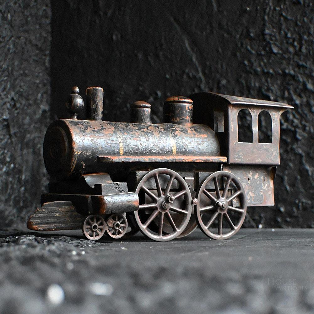 Early 20th Century American Scratch Built Toy Train   
A wonderful American folk-art example of an early 20th Century toy train. A bulbus form with some simple yet charming detail. Old metal cog wheels with hand carved pine wooden body and faded