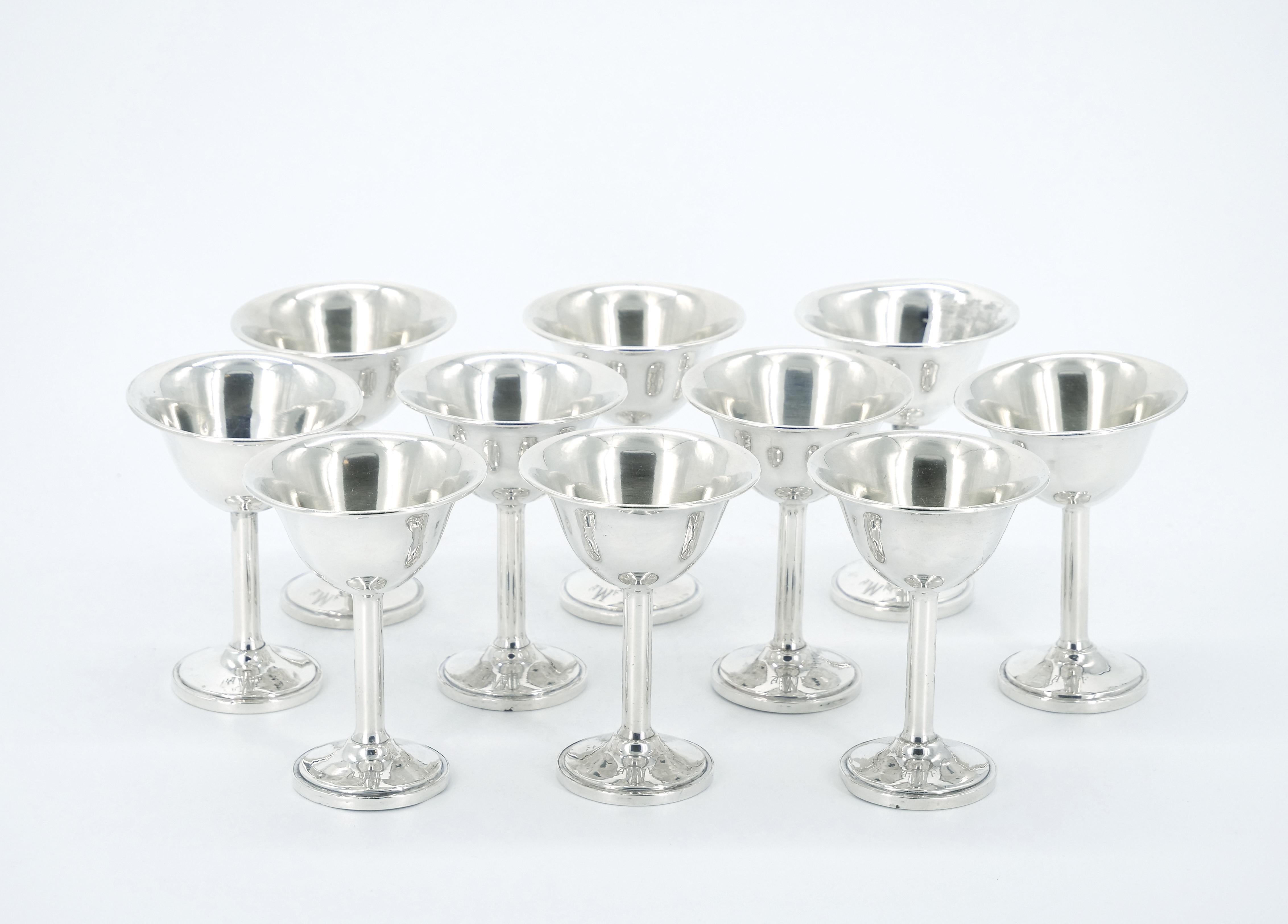 
Indulge in the timeless luxury of this early 20th century American sterling silver barware / tableware cordial's service, designed to cater to the refined tastes of ten people. Immerse yourself in the allure of this exceptional collection,