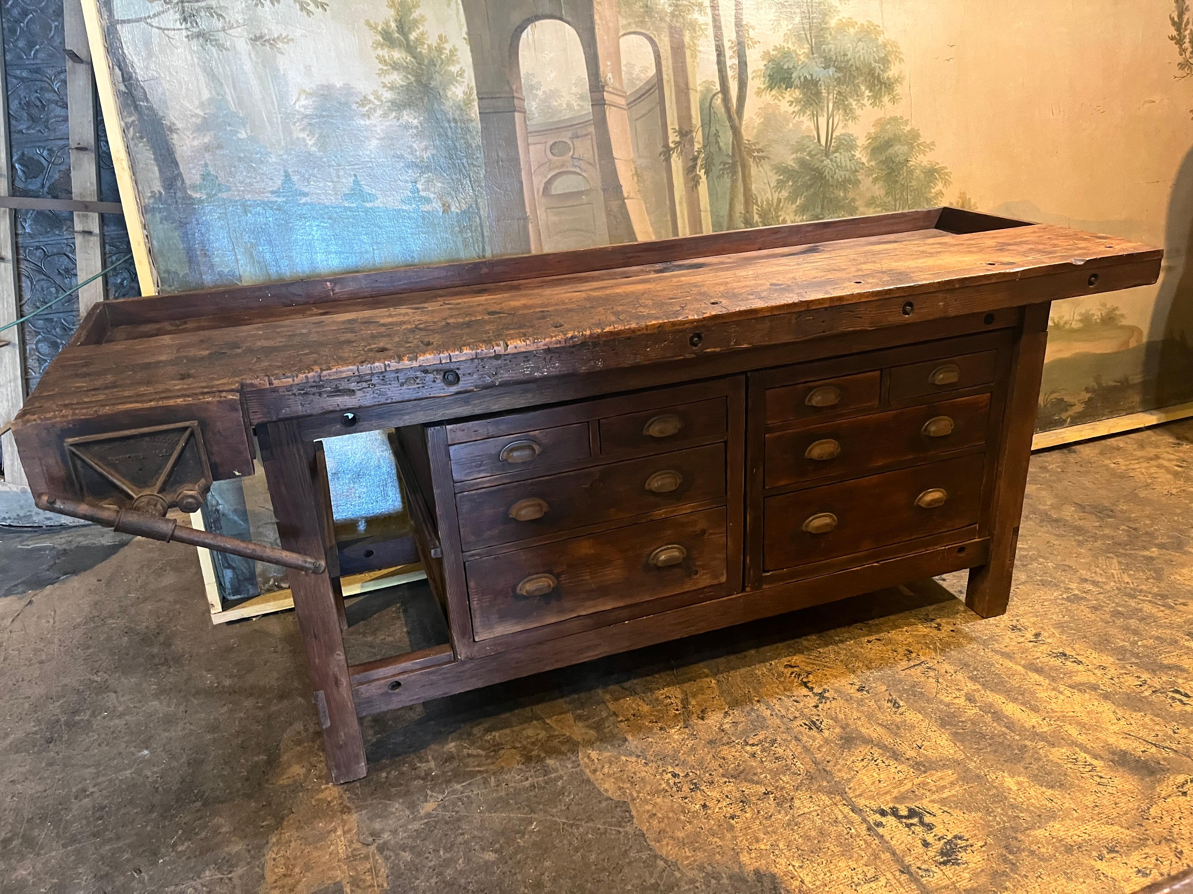 A very handsome early 20th century American Work Bench soundly constructed from beech and pine with its iron vice.  There are two removable drawer boxes - each with four drawers.  Some of the smaller drawers are compartmentalized.  Can be used with
