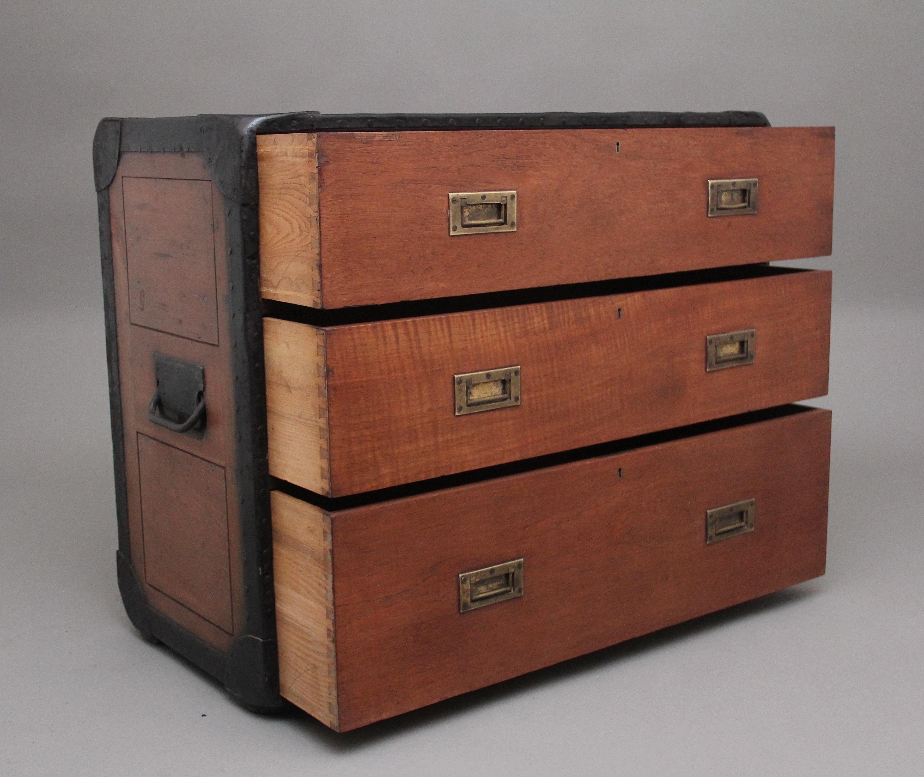 Early 20th Century Anglo-Indian camphor wood campaign chest, having three deep drawers with the original brass recessed handles, the sides of the chest having the original metal carrying handles, the chest having black metal straps around the edge