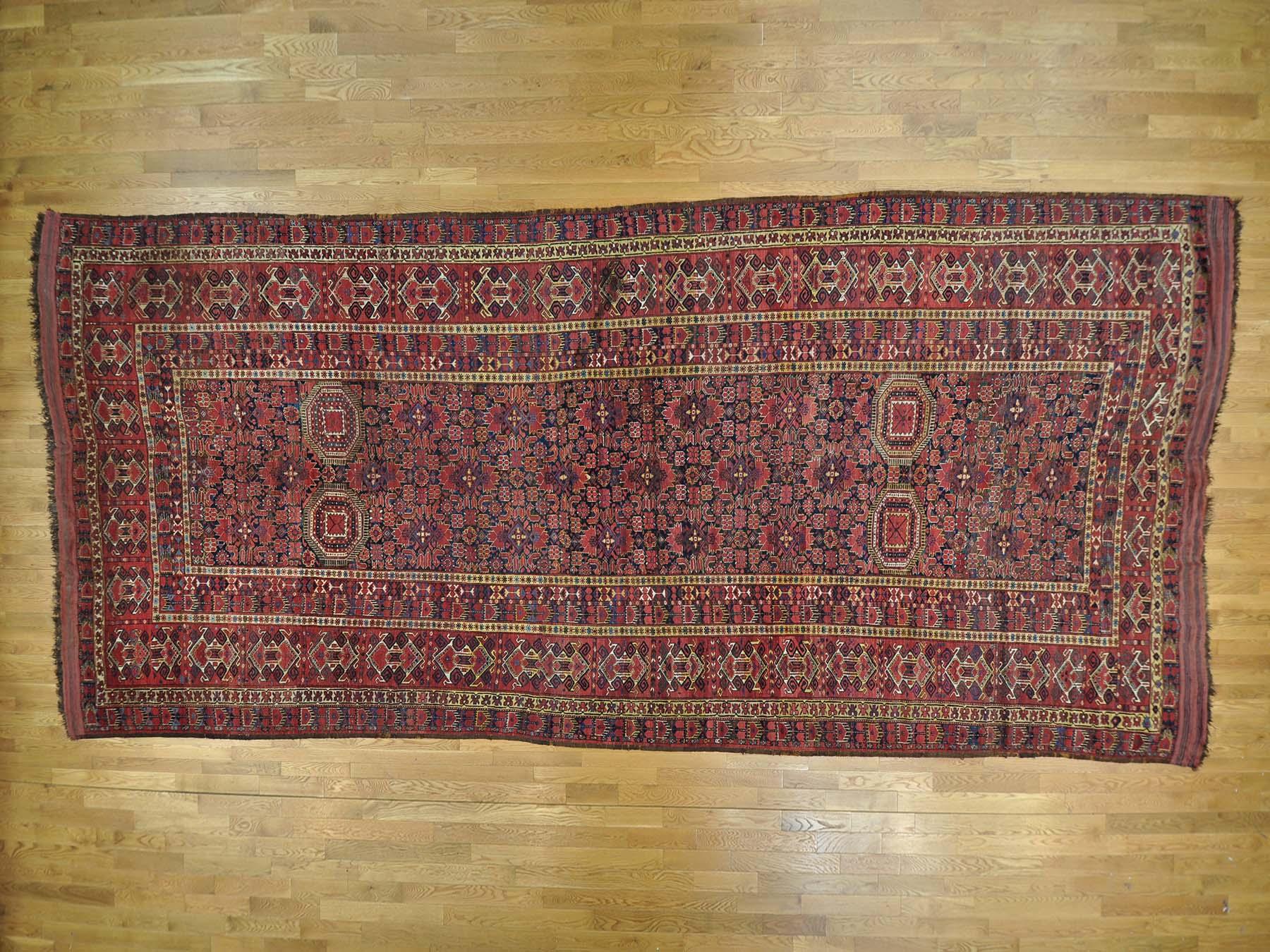 Enhance your home with this magnificent gallery size carpet. This handcrafted antique Afghan is an original beshir excellent condition pure wool oriental rug. This precise piece has been created for months and months in the centuries-old Persian