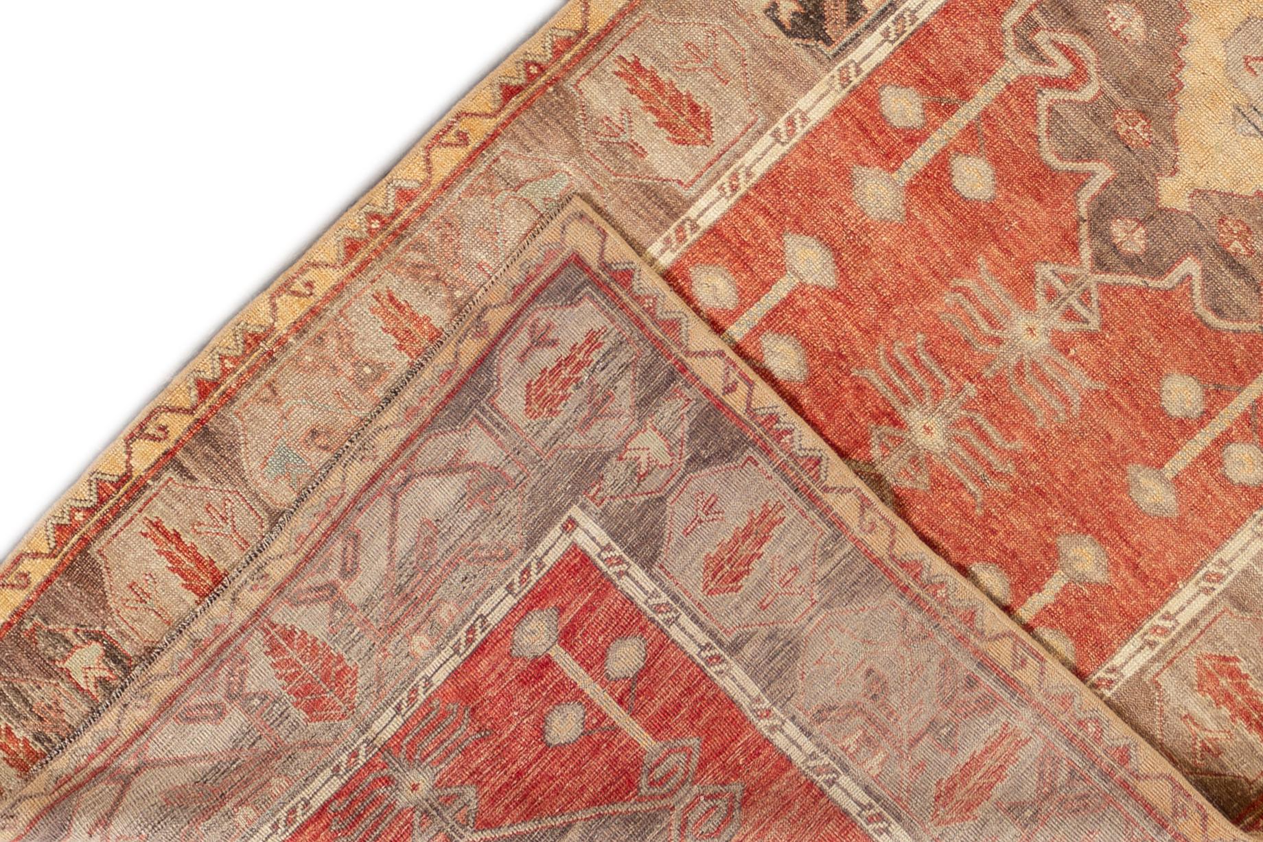 Beautiful antique Turkish Anatolian runner rug, hand knotted wool with a red field, brown frame and tan accents in all-over multi medallion design.
This rug measures 3' 6