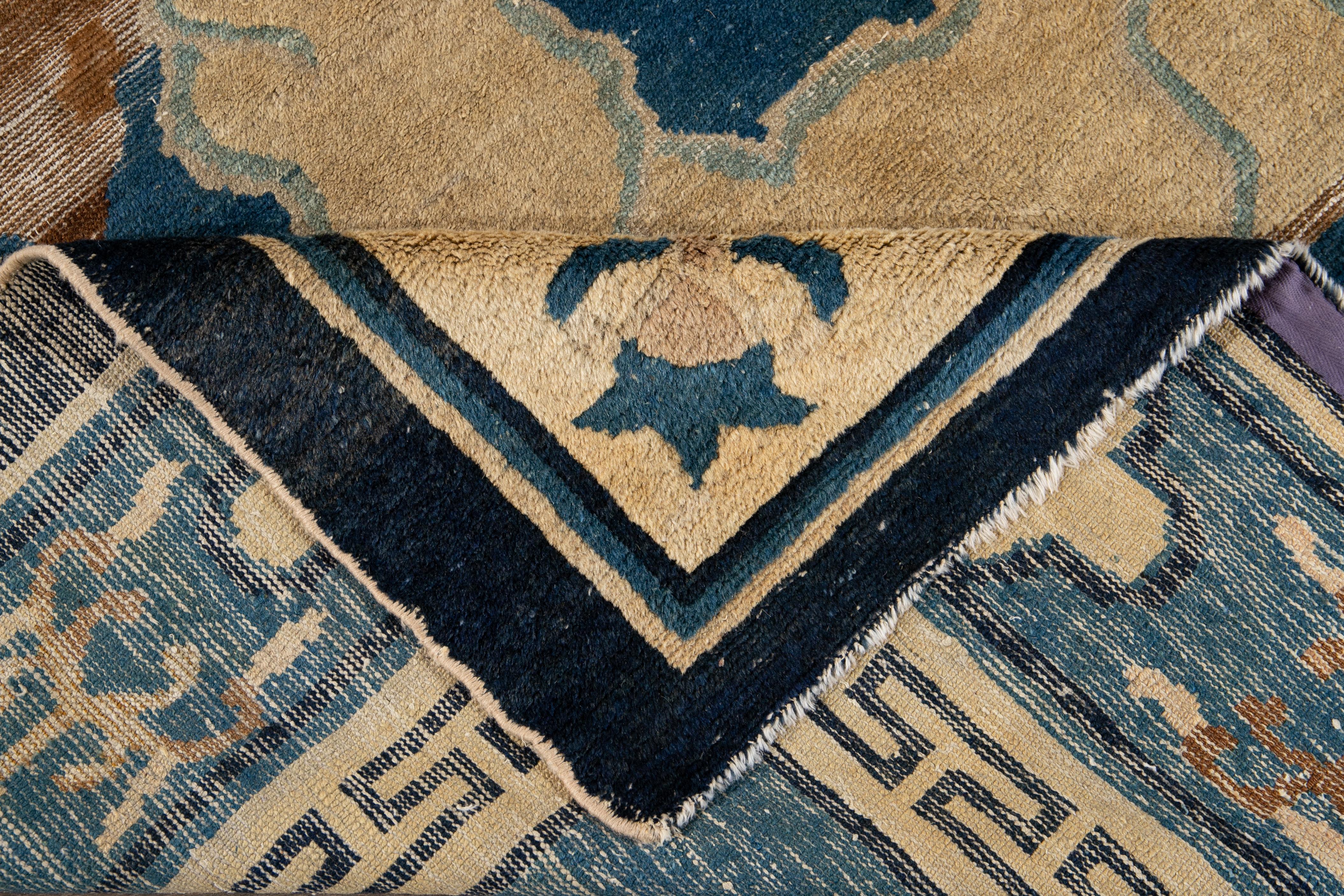 Beautiful antique Chinese Peking rug, hand knotted wool with a blue field, and beige accents in a subtle all-over Classic Chinese art design.

This rug measures: 7'8
