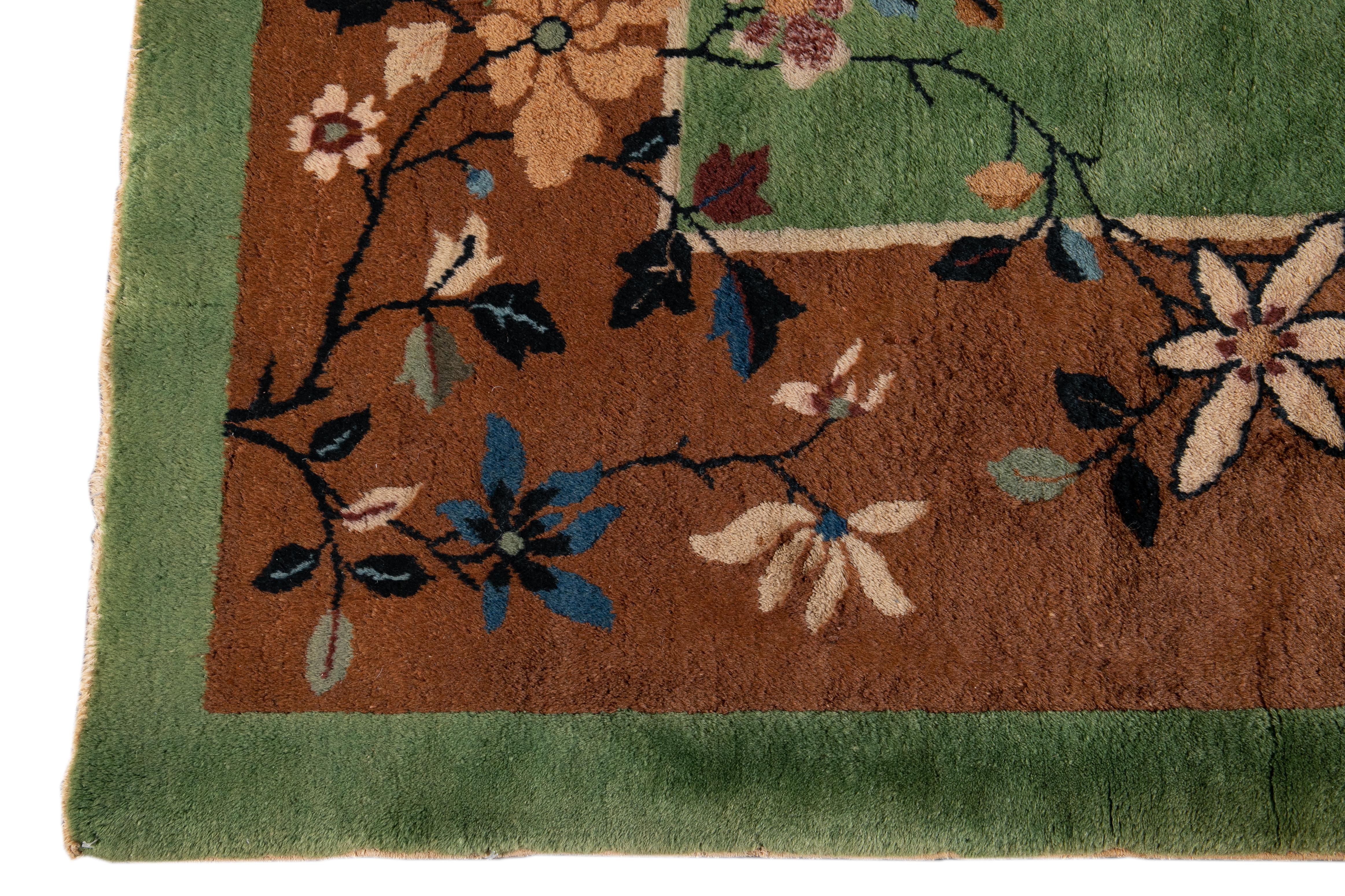 Beautiful Antique Art Deco Chinese rug, with a green field, brown frame in an allover classic Chinese floral design.
This rug measures 9' 0