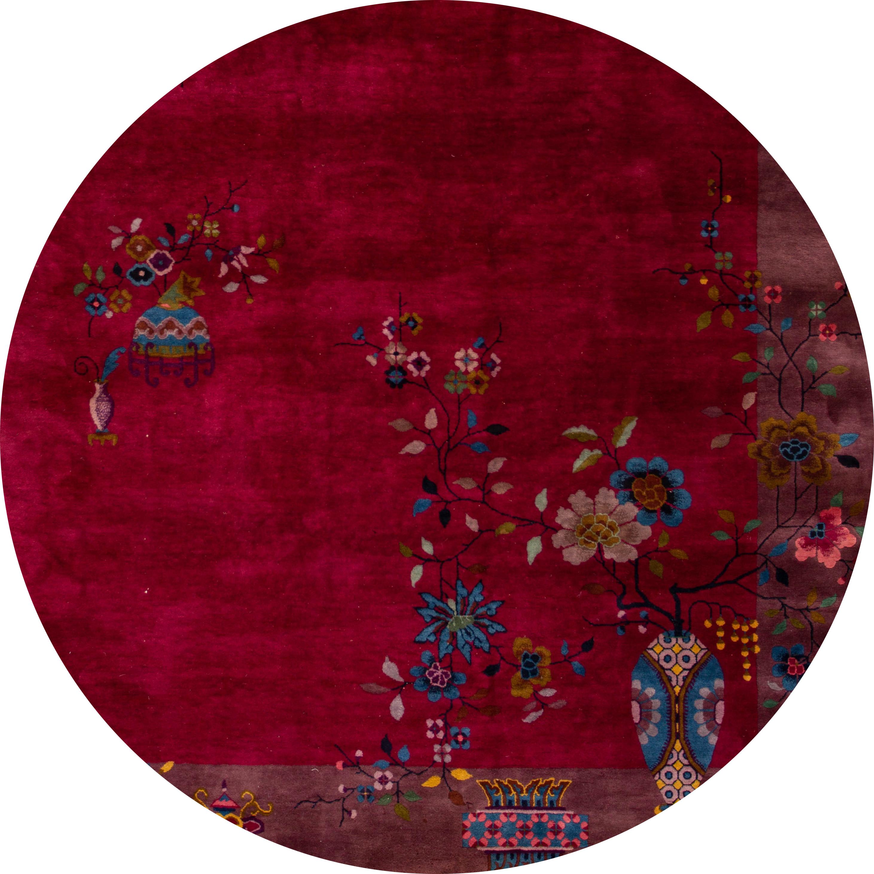 Beautiful antique Art Deco rug, hand-knotted wool with a deep burgundy field, dark lavender rame in an all-over Classic Chinese floral design, circa 1920
This rug measures 8' 10