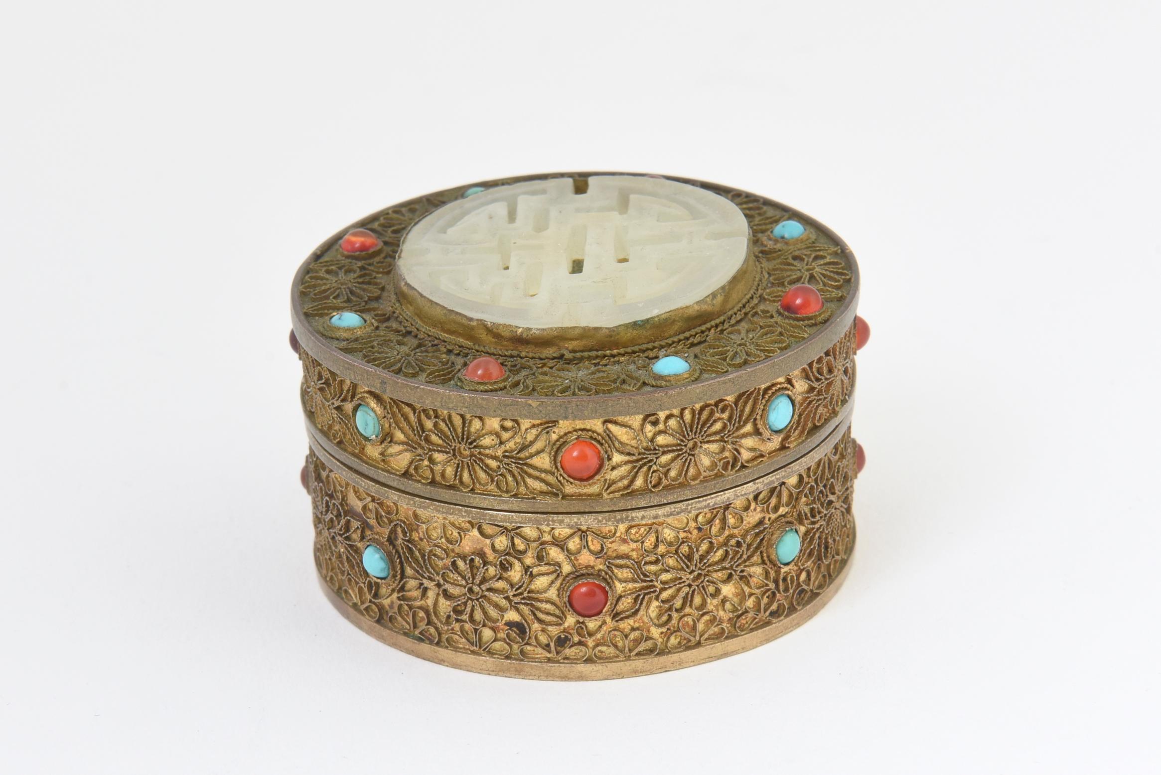 Asian gilt brass jewel box with carnelian and turquoise gemstones. Removable lid has carved Asian soapstone medallion on top. Age wear.