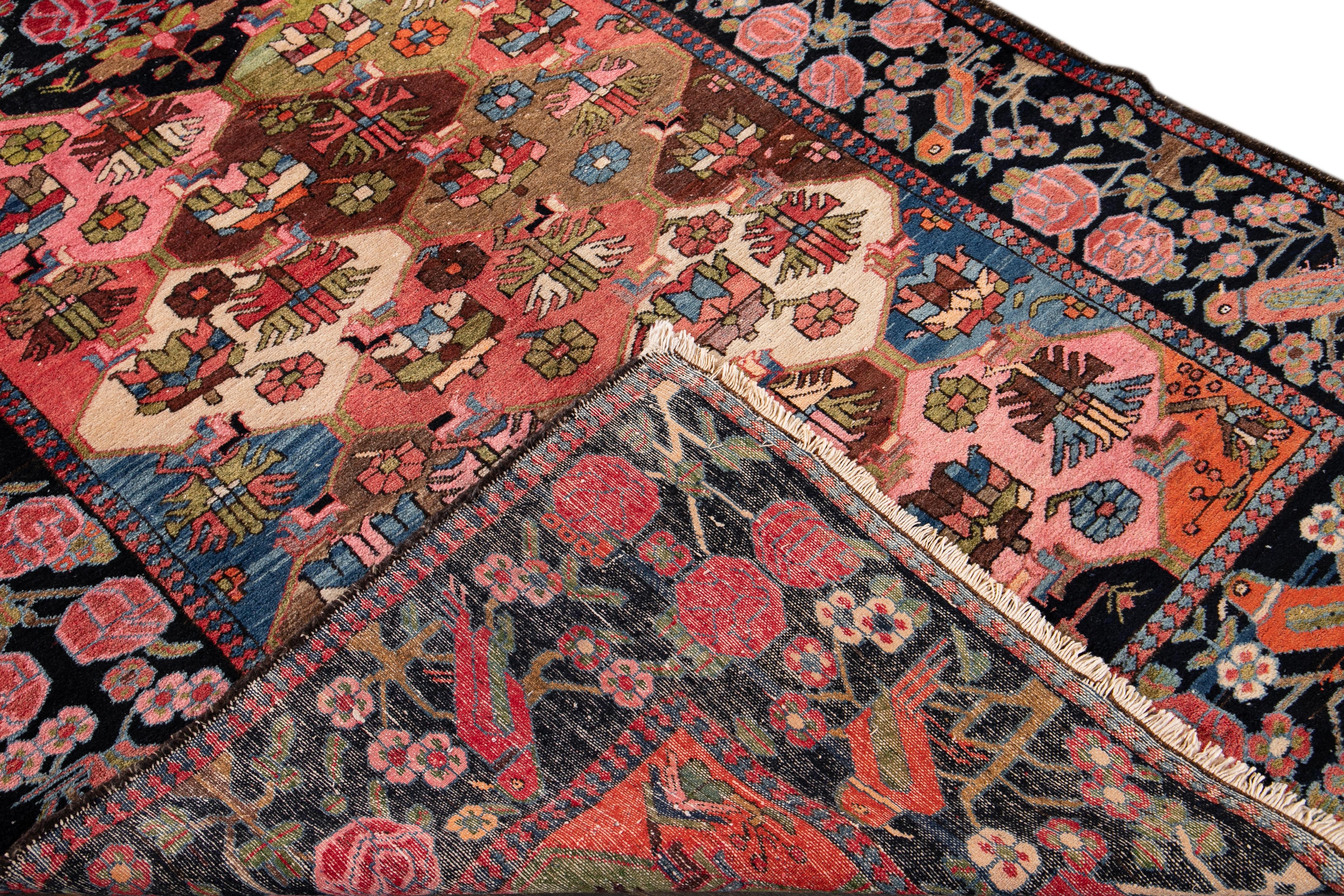 Beautiful antique Bakhtiari hand-knotted wool rug with a multicolor field. This Persian rug has a black frame in an all-over floral design.
circa 1930.
This rug measures 5' 3