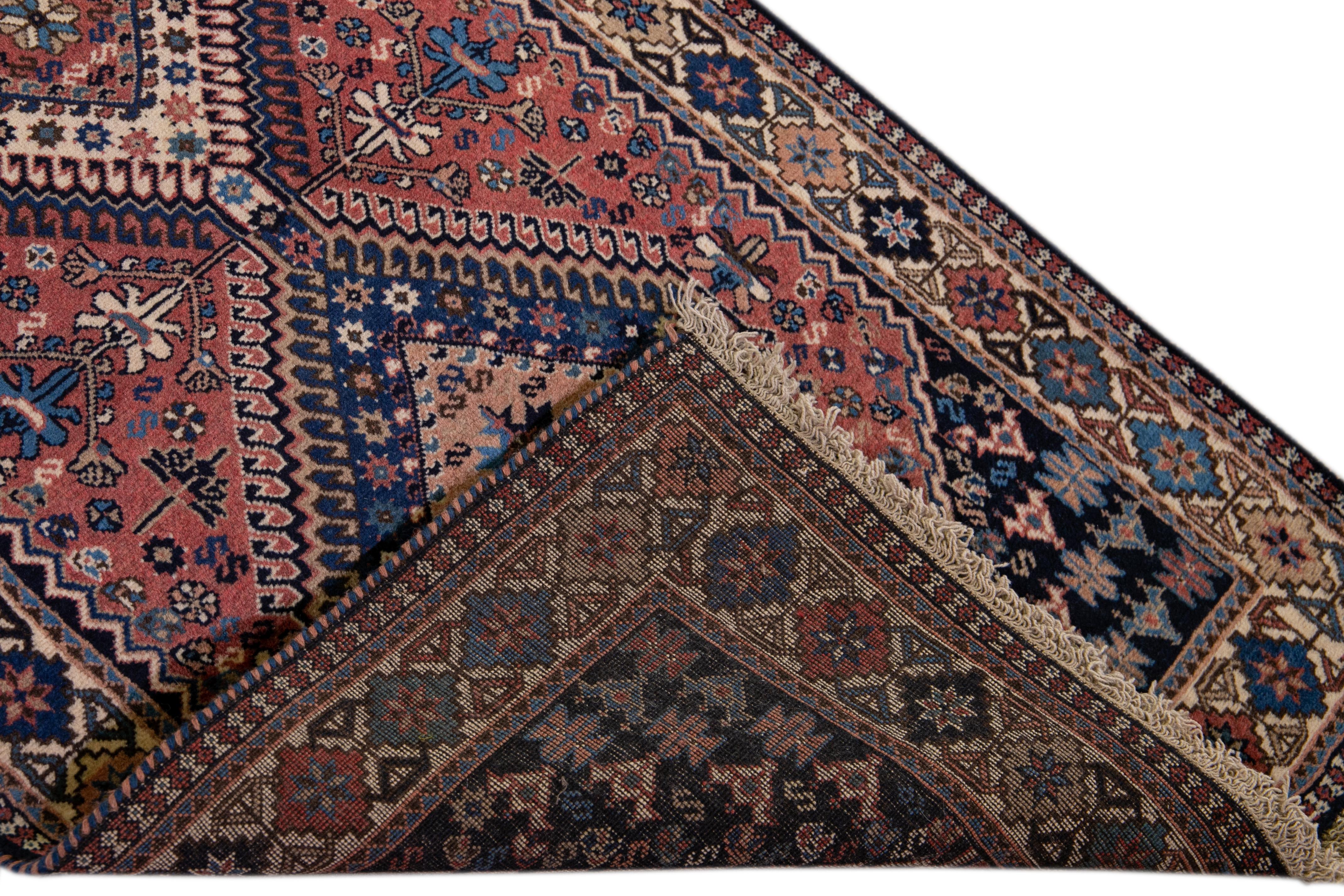 Beautiful hand-knotted vintage Bakhtiari wool runner. This rug has a rust field with a multicolored medallion geometric design all over,

This rug measures 2' 8