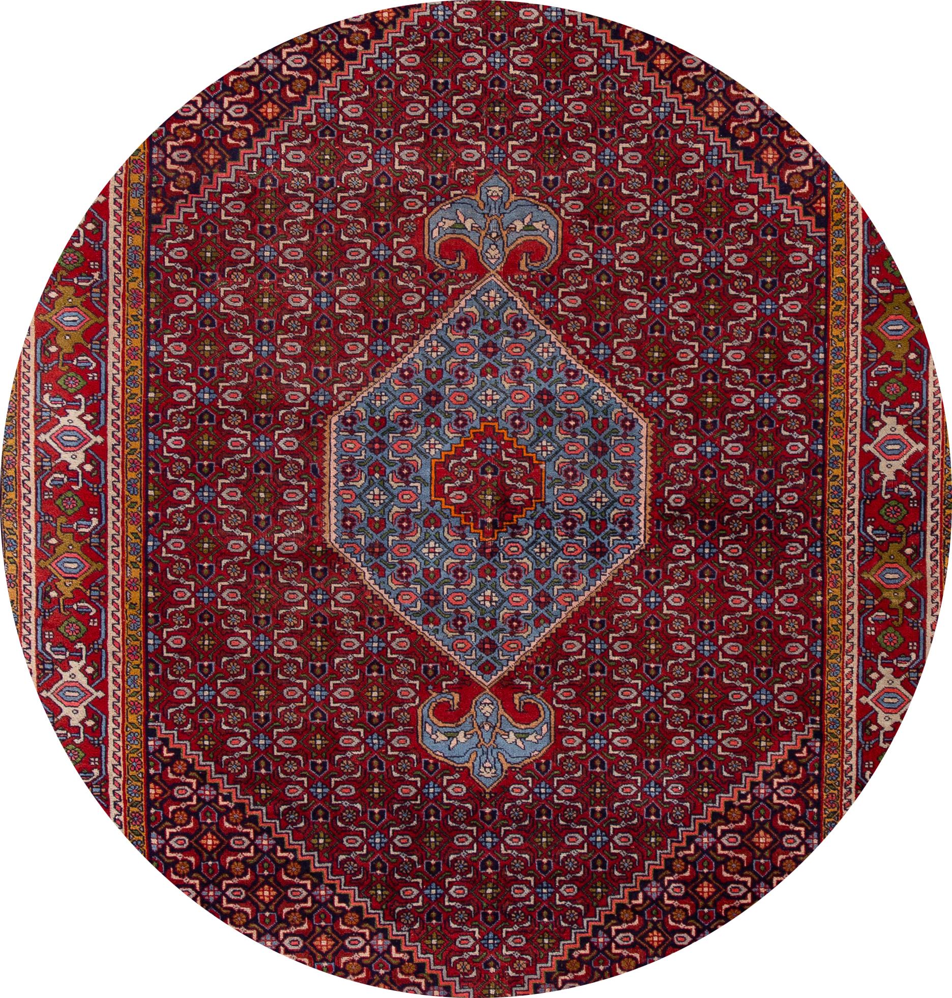 Beautiful antique Bidjar rug, hand knotted wool with a red field, blue and ivory accents in center medallion design,
circa 1930.
This rug measures 6' 7