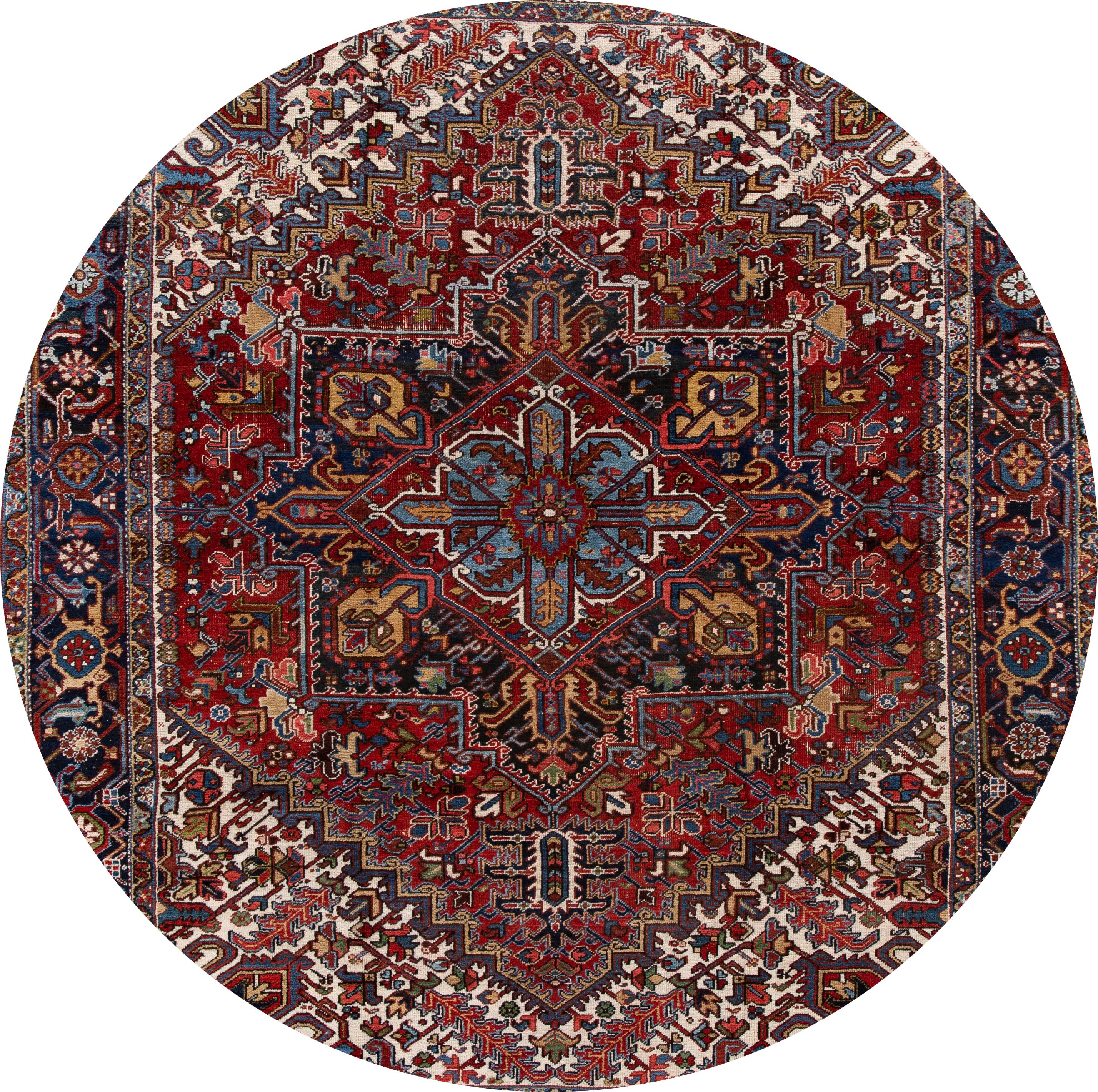Beautiful antique Heriz rug, hand knotted wool with a navy field, red and tan accents in an all-over Classic motif.
This rug measures 8' 7