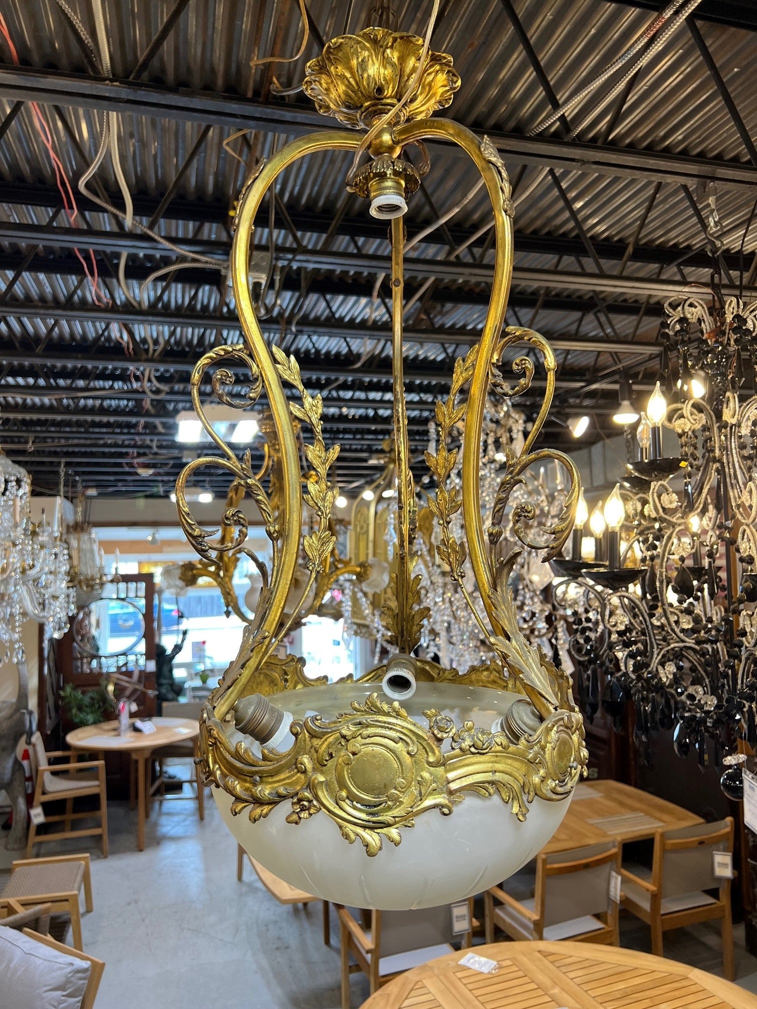 Early 20th century bronze hanging chandelier with a cut glass bowl. Beautiful bronze filigree around the top of the bowl and decorative arms. A glass shade is missing on the top and looks like it was rewired but still has the original sockets should