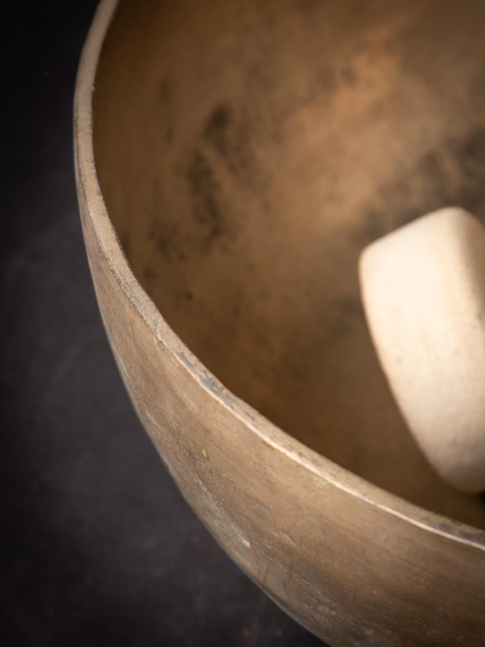 This antique bronze Nepali Singing bowl originates from Nepal and dates back to the early 20th century. Crafted from bronze, it showcases the rich cultural heritage of Nepal. The bowl stands at a height of 16 cm with a diameter of 35.5 cm, making it