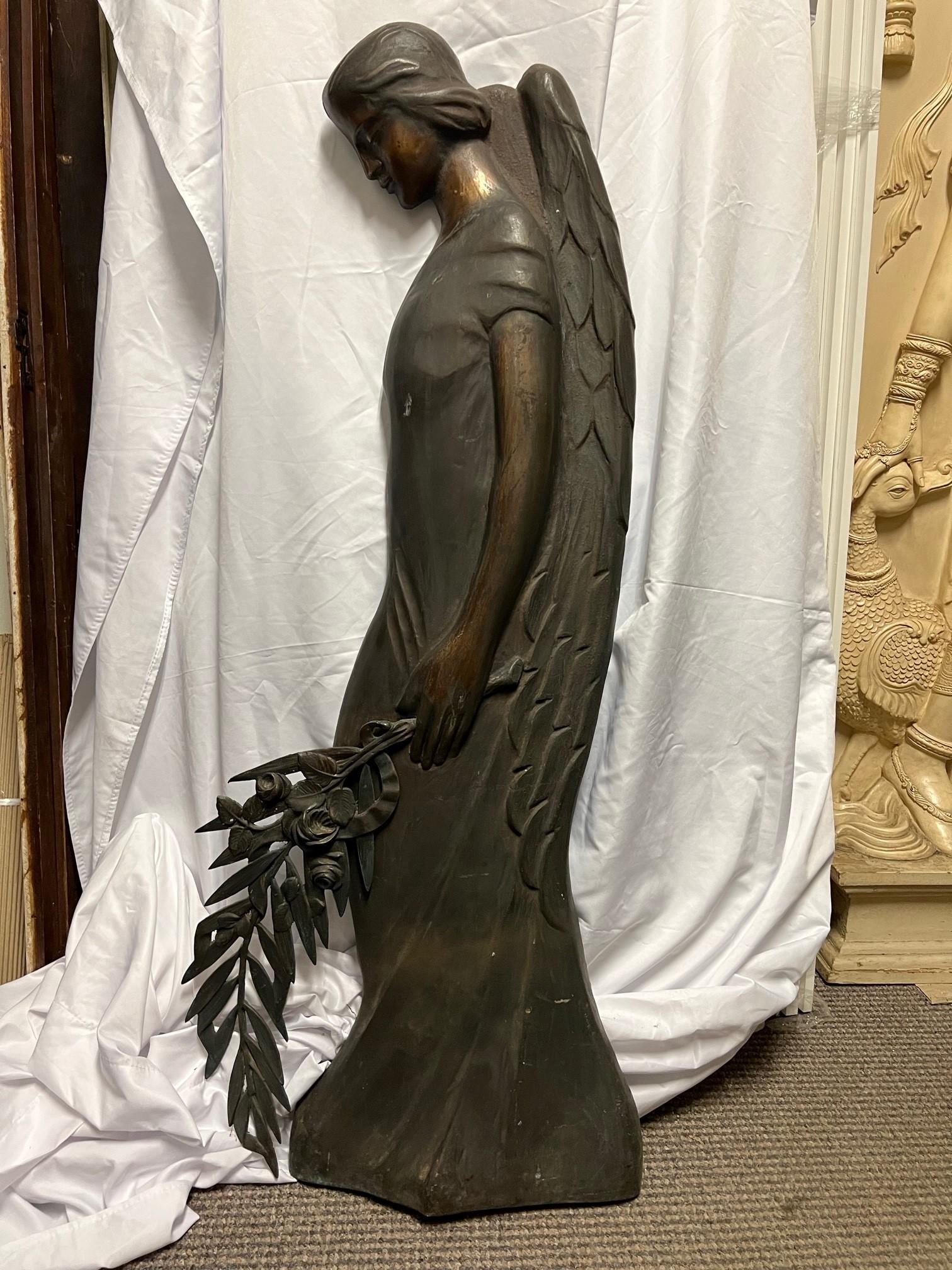 Hard to find early 20th century antique bronze praying angel holding palms mourning the death of a loved one. The palm branch is a Christian symbol of eternal life and triumph over death. Angels represent the connection between heaven and earth, as