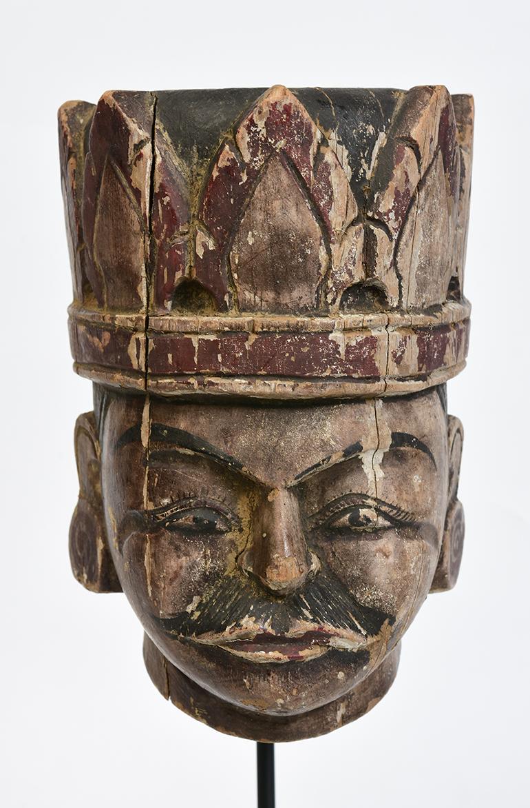 Burmese wooden puppet head with stand.

Age: Burma, Early 20th century
Size: Height 19 C.M. / Width 13.7 C.M. / Thickness 13 C.M.
Size including stand: Height 36.4 C.M.
Condition: Nice condition overall (some expected degradation due to its