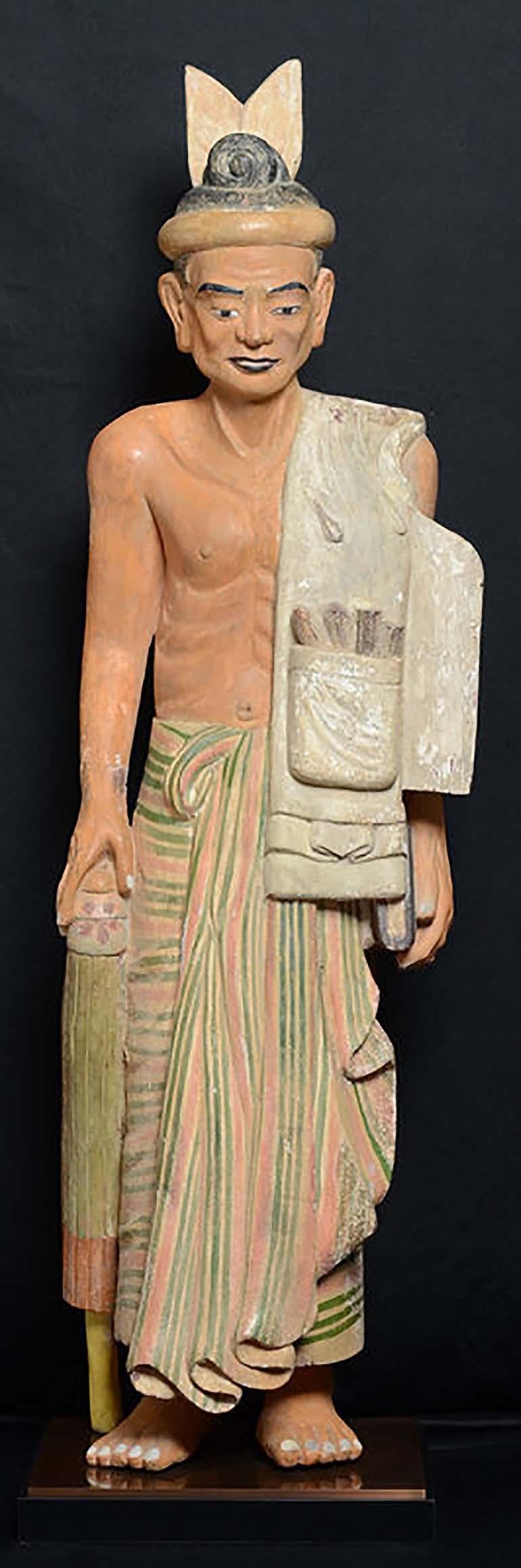 Antique Burmese wooden standing old man.

Age: Burma, Early 20th Century
Size of figure only: Height 111 C.M. / Width 34 C.M.
Height including stand: 115 C.M.
Condition: Nice condition overall (some expected degradation due to its age). 

100%