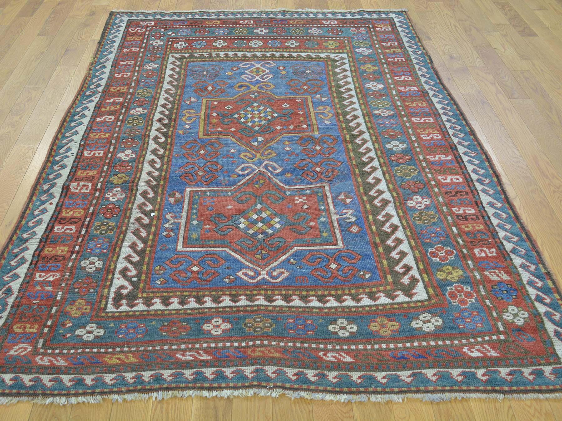 Bring life to your home with this fascinating antique carpet. This handcrafted Caucasian Karachopf is an original excellent condition hand knotted oriental rug. This limited piece has been knotted for months and months in the centuries-old Persian