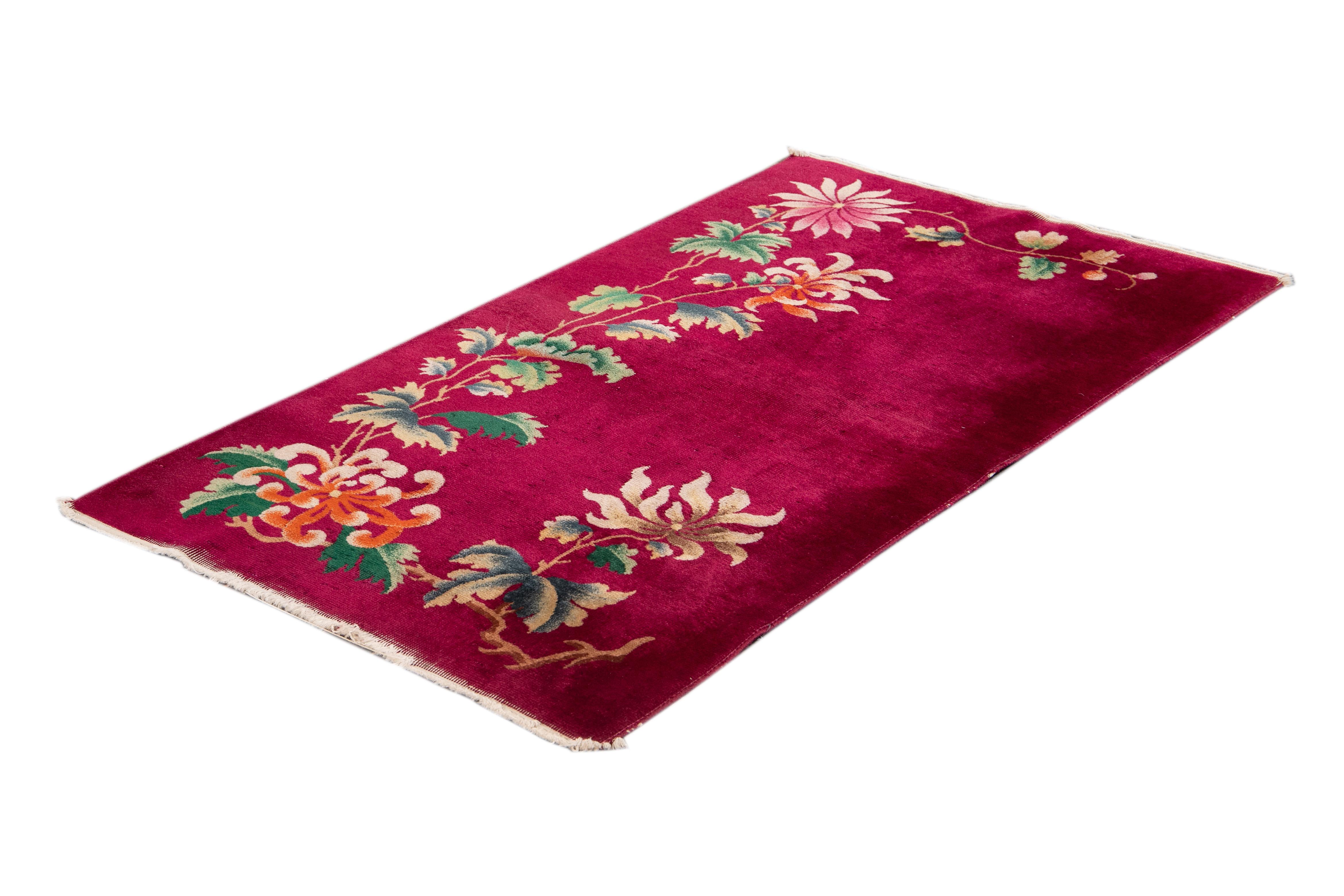 Beautiful vintage Chinese Art Deco rug with a magenta field and multi colored accents with an all over floral design. 

This rug measures 3' 0