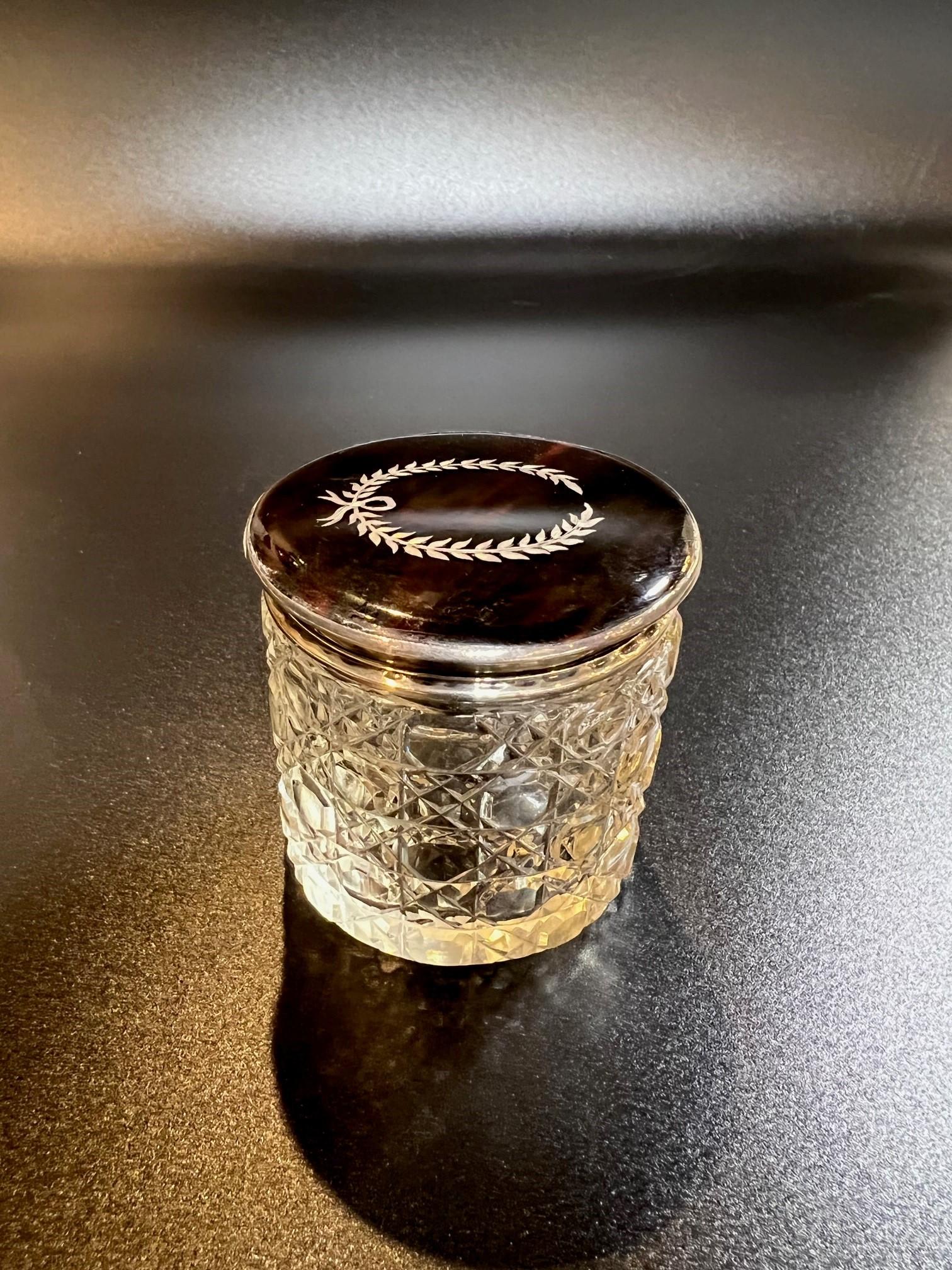 Early 20th century English cut crystal dresser jar with a tortoise shell and sterling silver lid with inlay. This is a beautiful and hard to find piece from a private collector who traveled the world buying beautiful items. A very nice looking piece