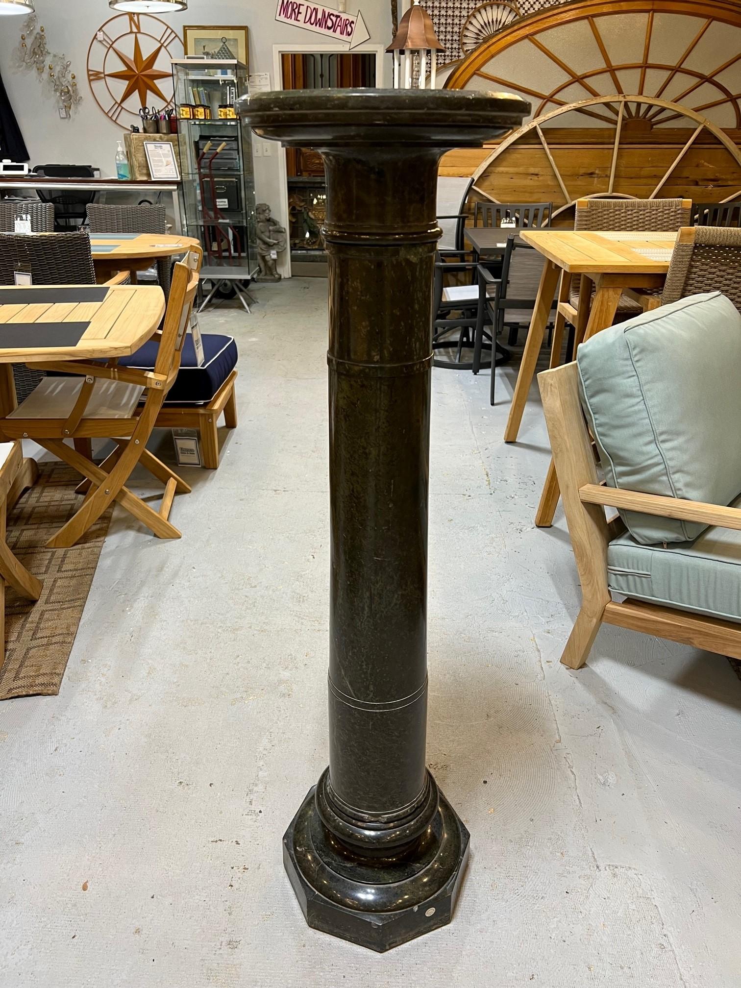 A fine early 20th century maybe late 19th century dark green marble pedestal. The pedestal is raised by an octagon base with a mottled circular design with a round top. The pedestal is a great size that breaks down in three pieces making it easier