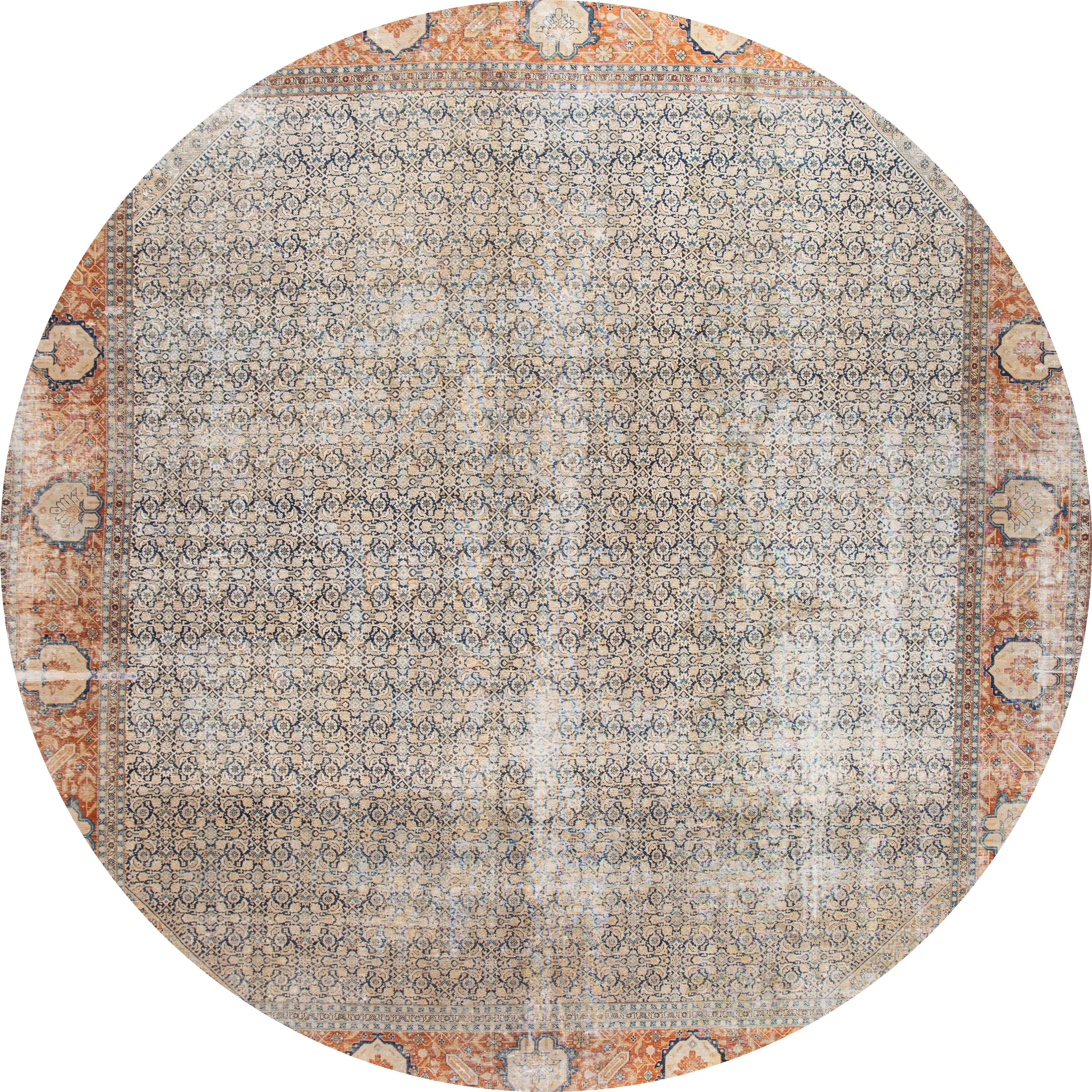 An antique distressed Tabriz square rug with a gray field and peach and blue accents in a symmetrical, interconnected floral and vine design. This hand knotted wool.
This rug measures: 13