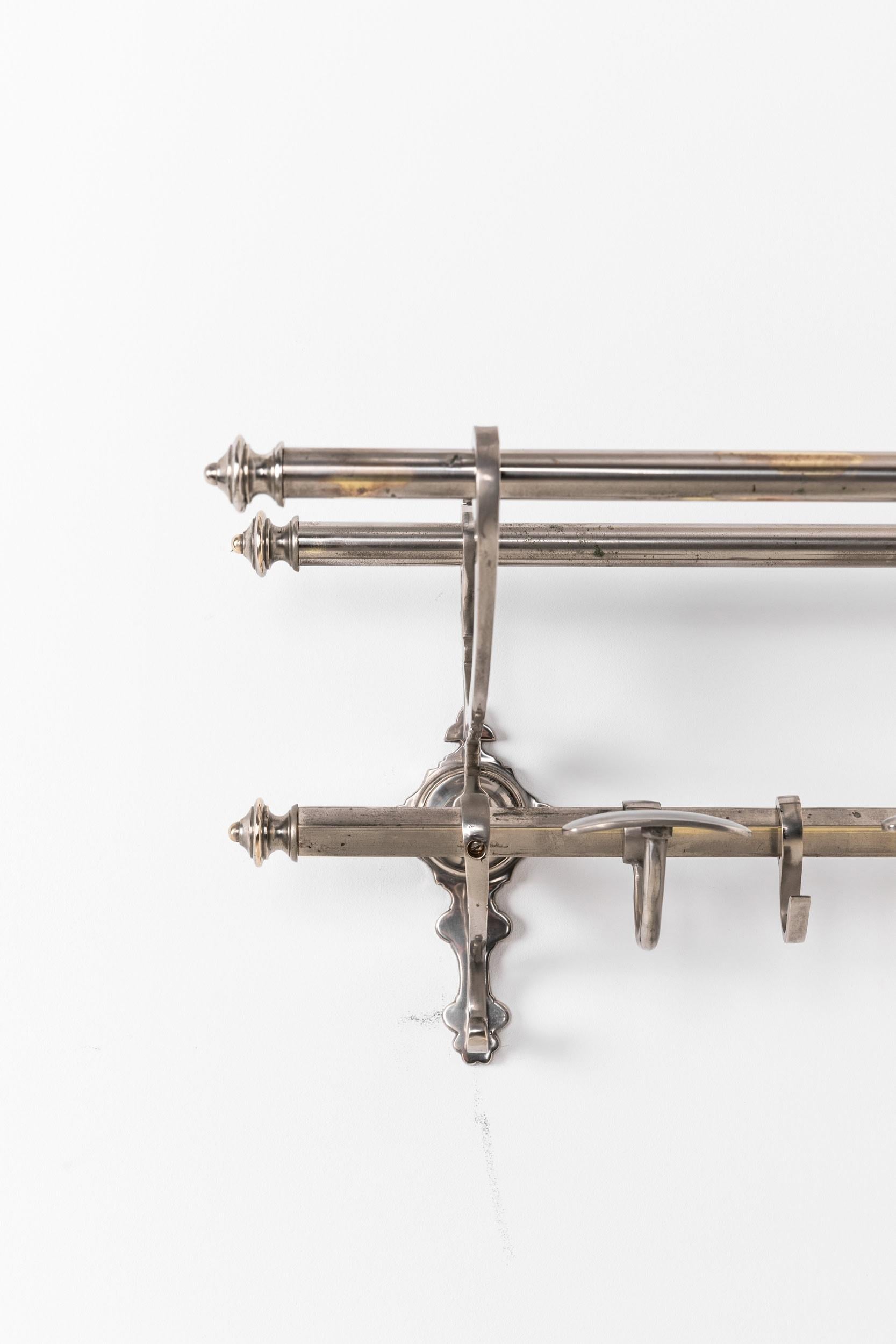 

An incredibly elegant wall mounted hat and coat rack. French, c.1930

Of very high quality, nickel plated brass. Two top rails over single square rail with moveable hooks. A beautiful and functional addition to a hallway or cloakroom.
