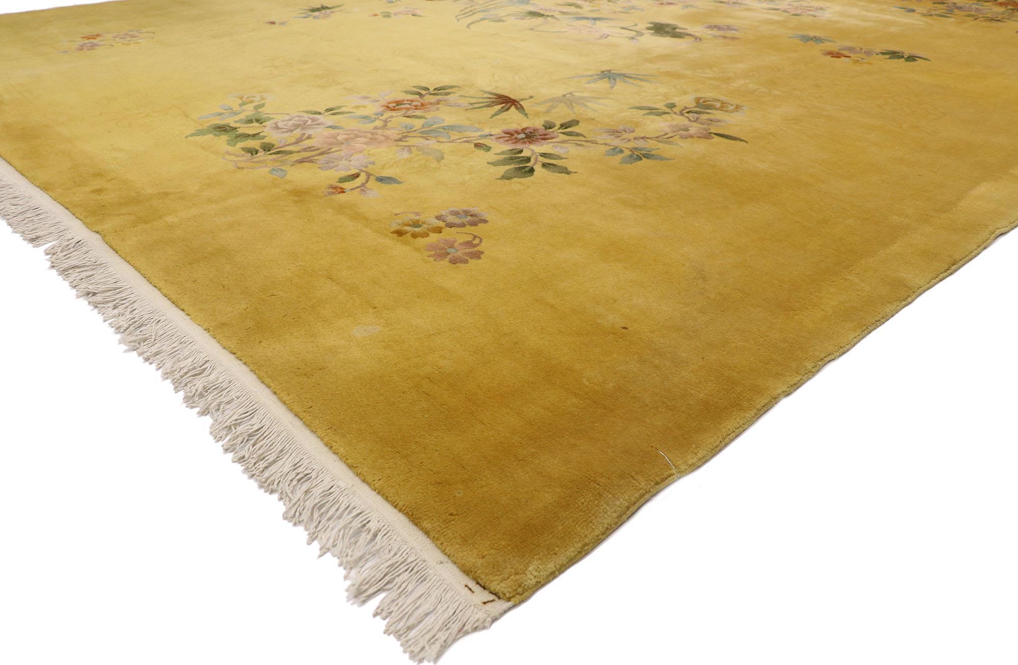 77391, early 20th century antique gold Chinese Art Deco rug inspired by Walter Nichols. This hand knotted wool antique Chinese Art Deco rug features asymmetrical arrangements of Peony flowers, plum blossoms, tantalizing sprays of bamboo, and an