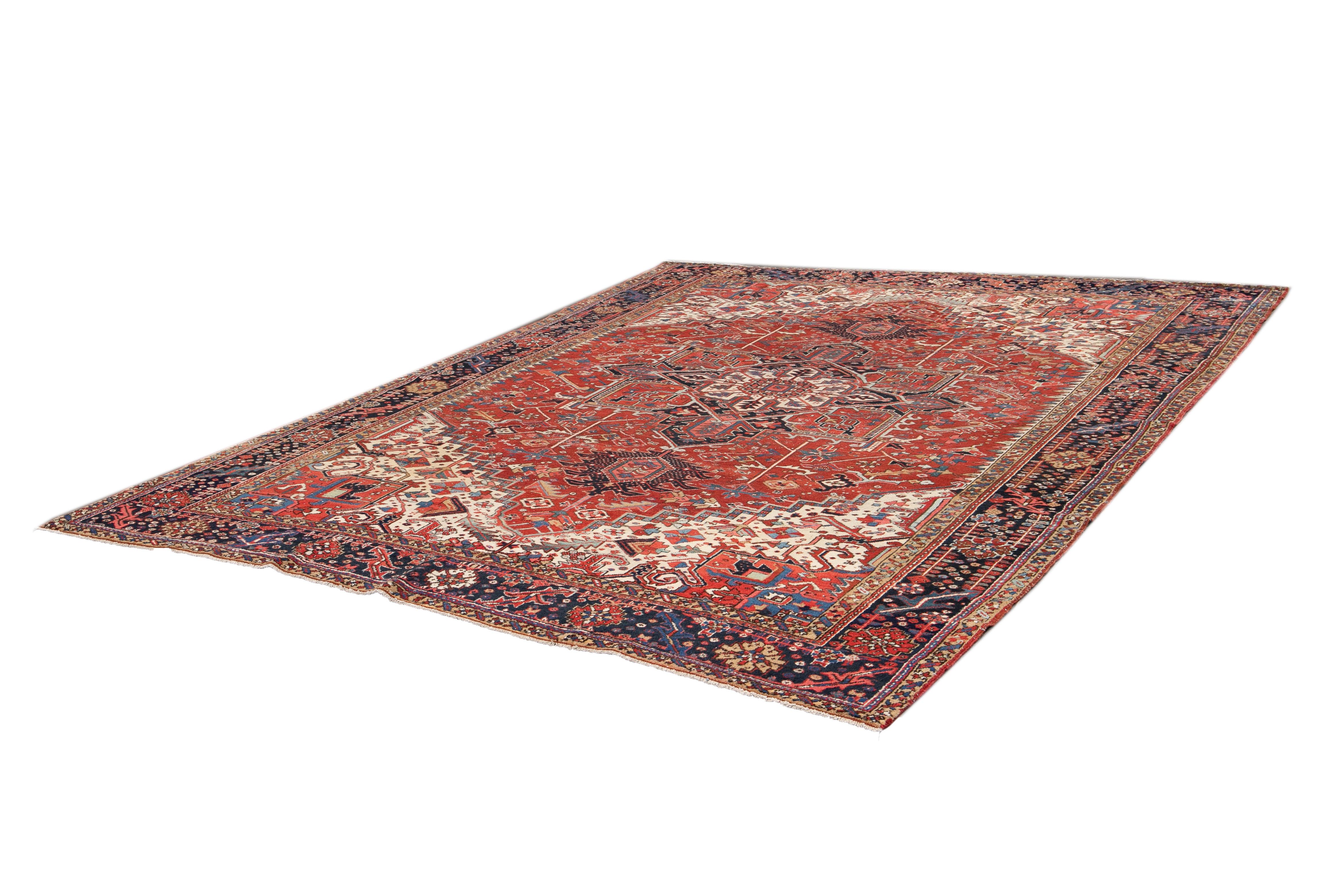 Beautiful vintage Heriz rug with a rust field and ivory accents with an all-over medallion design. 

This rug measures 9' 3