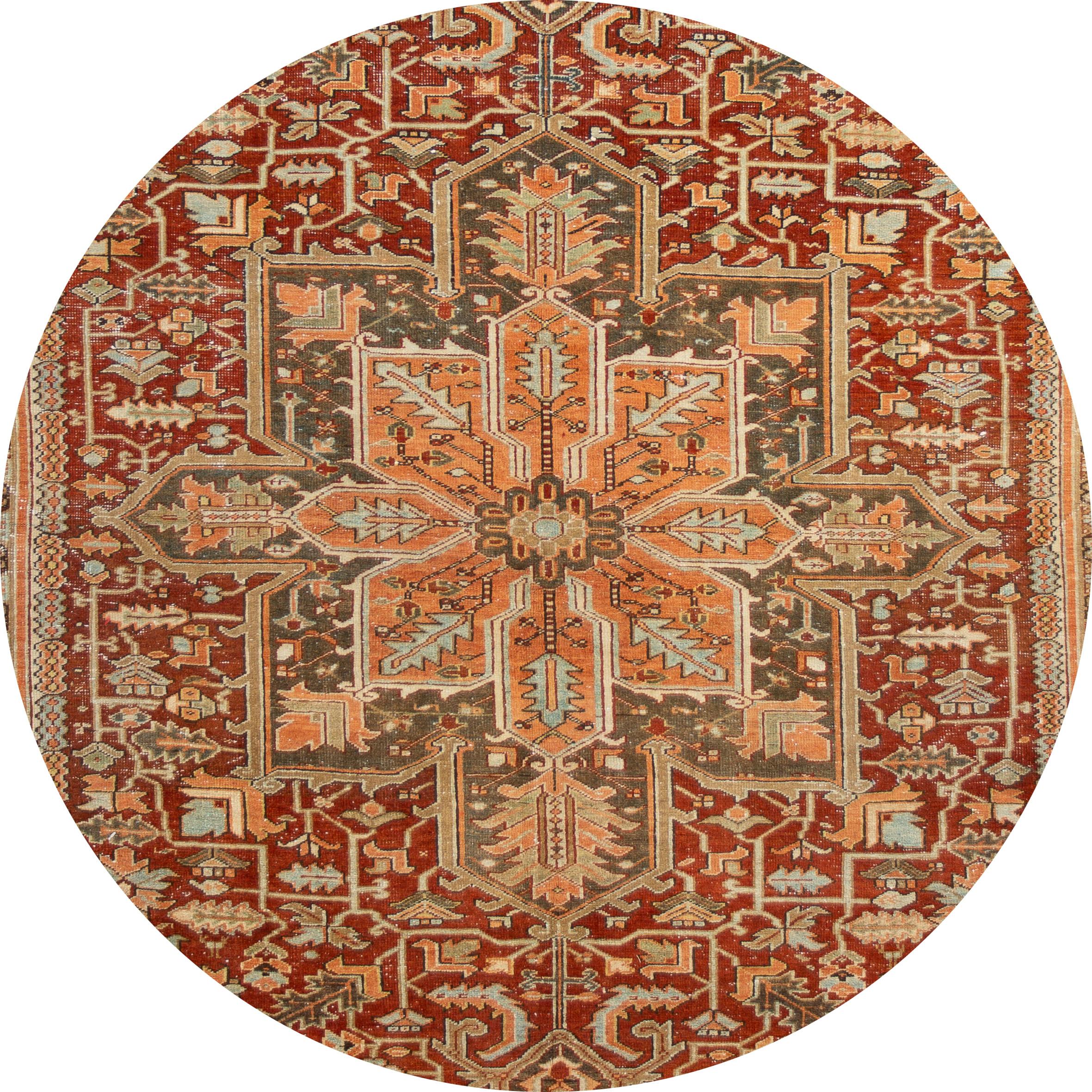 Beautiful antique Heriz rug, hand knotted wool with a rust field, tan and blue accents in all-over center medallion design,
circa 1920.
This rug measures 9' x 12' 1