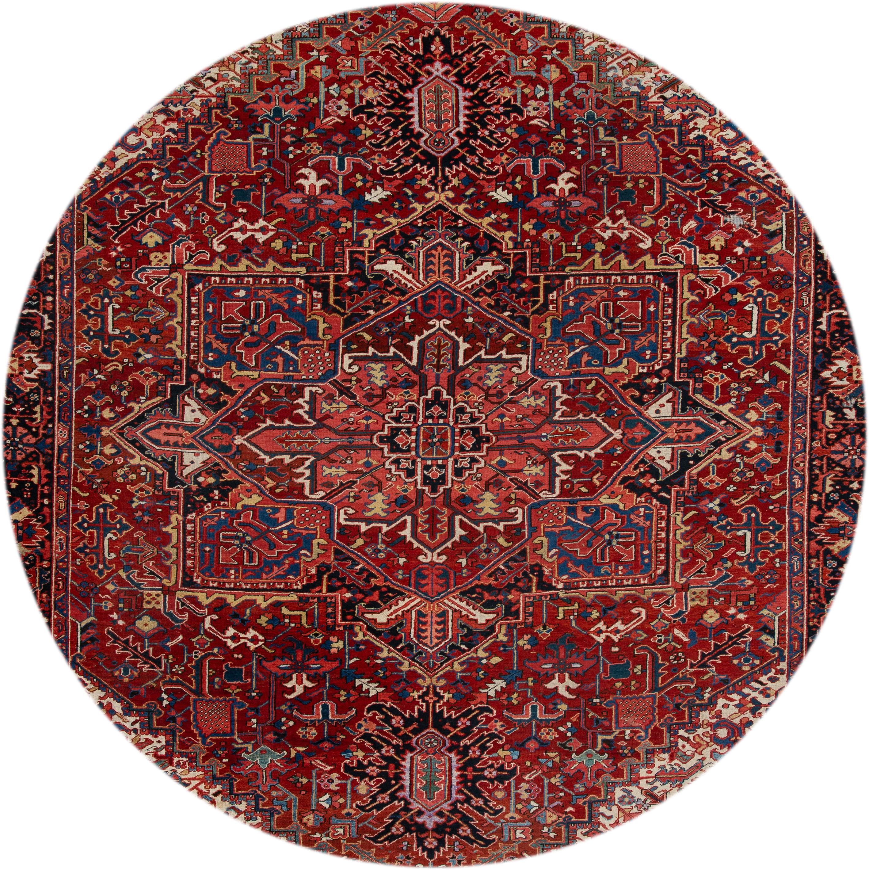 Beautiful antique Heriz hand-knotted wool rug with a red field. This Persian rug has ivory and blue accents in an allover center medallion design,
circa 1920
This rug measures 11' x 14'.