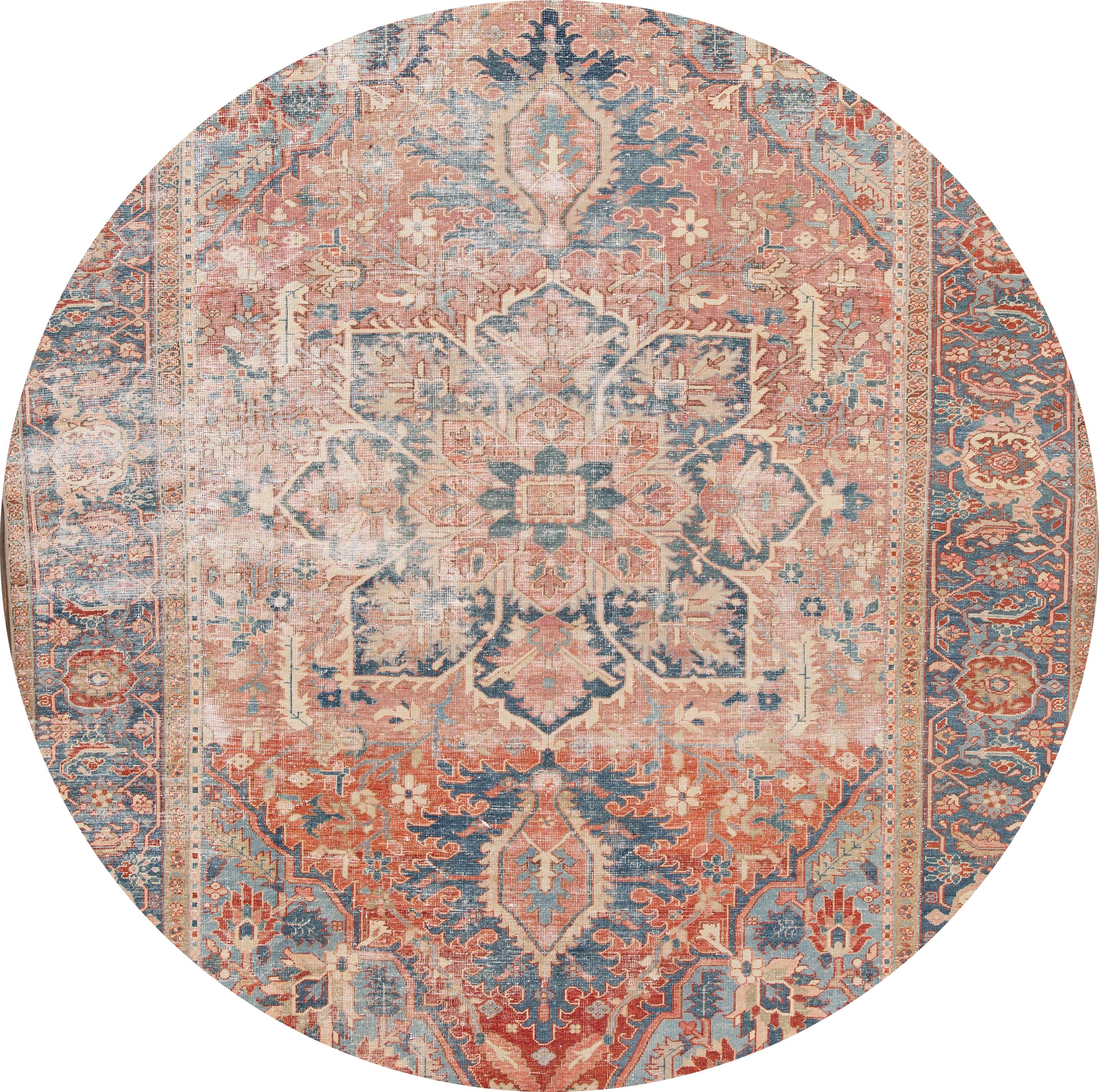 Beautiful antique Heriz rug, hand knotted wool with a peach field, red and blue accents in all-over center medallion design,

This rug measures 9' 6