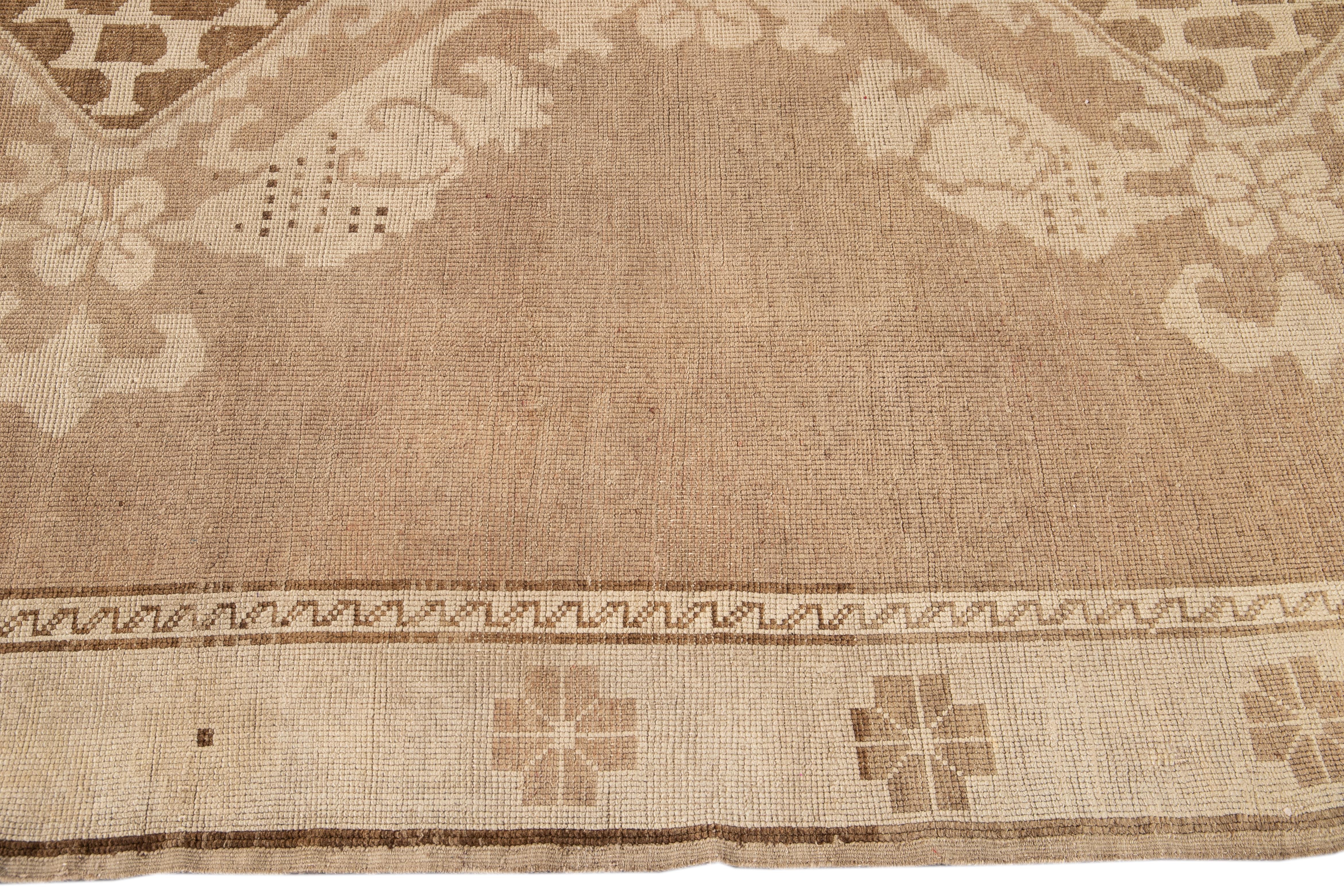 Early 20th Century Brown Antique Khotan Wool Rug with Medallion Design In Excellent Condition For Sale In Norwalk, CT