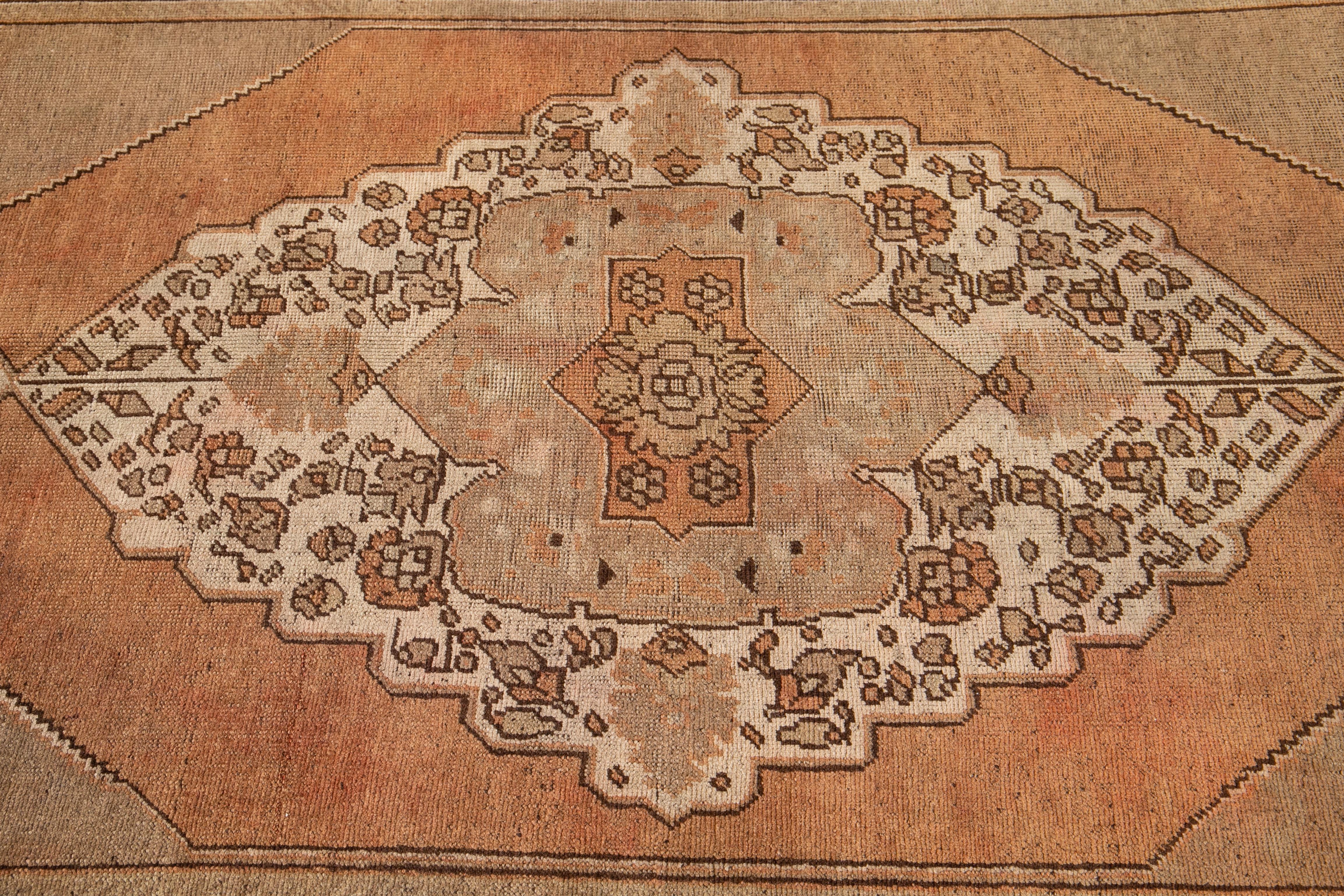 Hand-Knotted 20th Century Antique Handmade Khotan Wool Rug With Orange Rust Color Field  For Sale