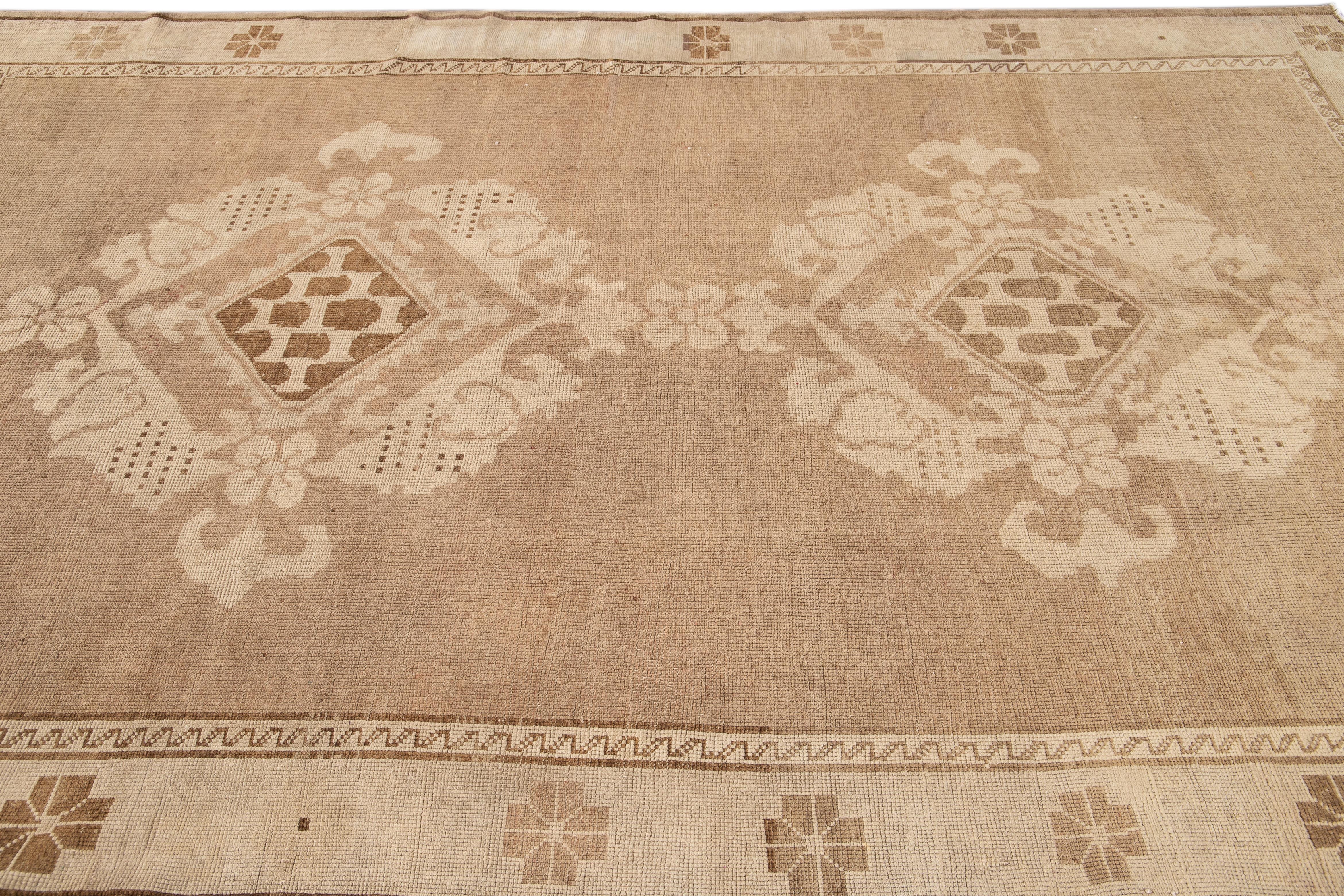 Early 20th Century Brown Antique Khotan Wool Rug with Medallion Design For Sale 1
