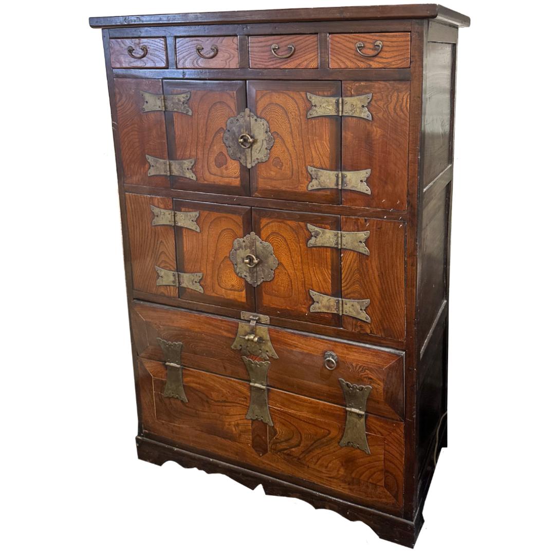 This Early 20th-Century Korean Tansu Chest is a stunning example of traditional craftsmanship, featuring intricate hand-forged hardware and a beautifully aged patina. With its ample storage and versatile design, it serves as both a functional piece