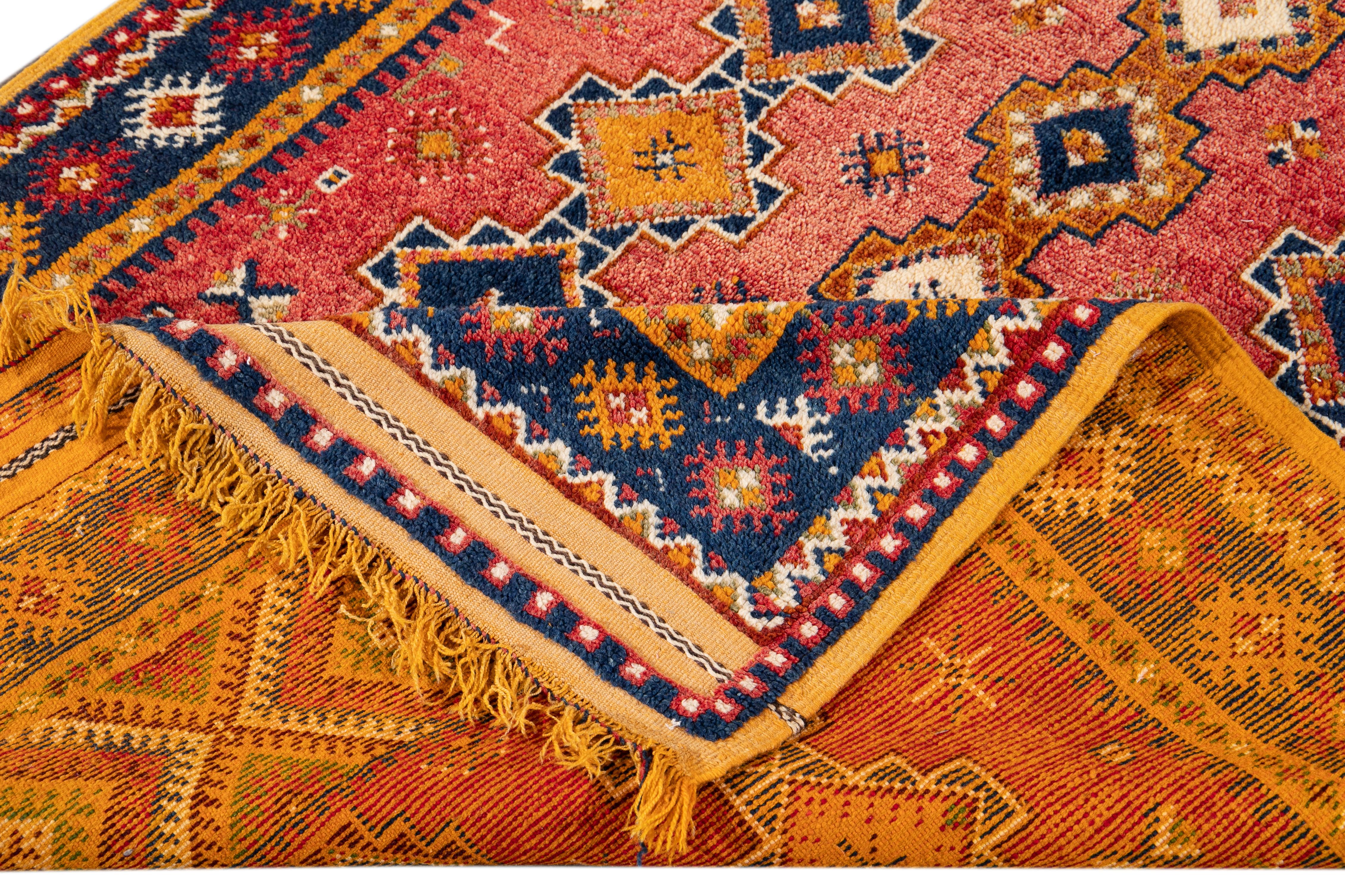 Schöner antiker marokkanischer Teppich mit blauer und gelber Doppelbordüre, rotem Feld und durchgehendem geometrischem Muster in Blau- und Orangetönen. 

Dieser Teppich misst 4'8