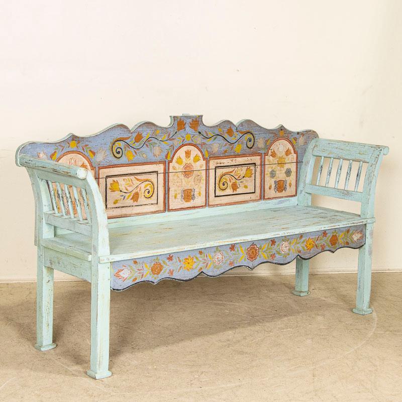 This delightful bench still maintains its original blue paint with a whimsical array of flowers and flourishes in the traditional folk art style of the era. The bright colors of red, yellow and blue were favorites in Romania, and their exuberant