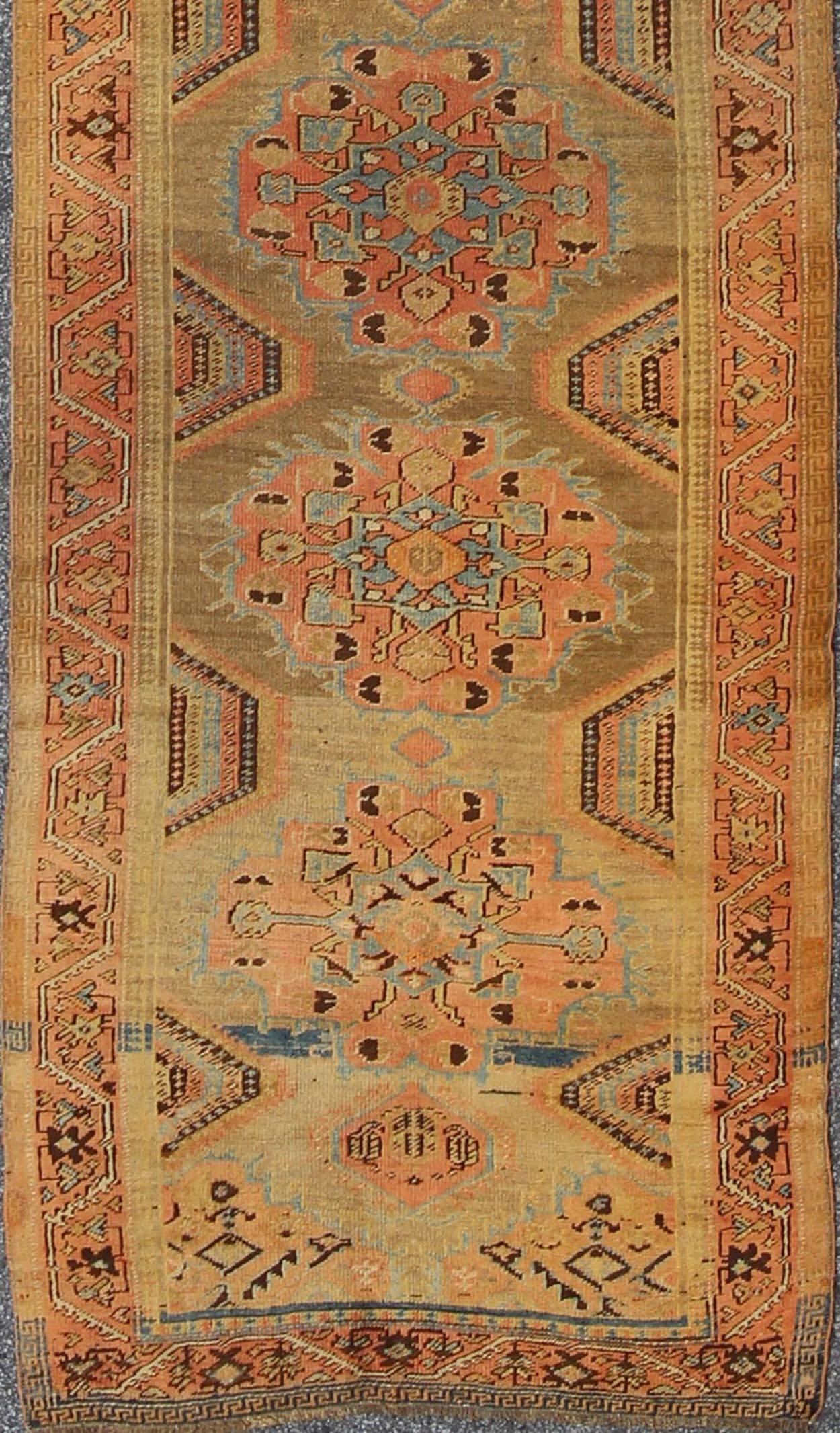Early 20th century antique Oushak runner with medallions in sand, pink and blue, rug chm-2306, country of origin / type: Turkey / Oushak, circa 1920

This compelling and unique Oushak runner was made in the early 20th century, circa 1920, in Turkey.