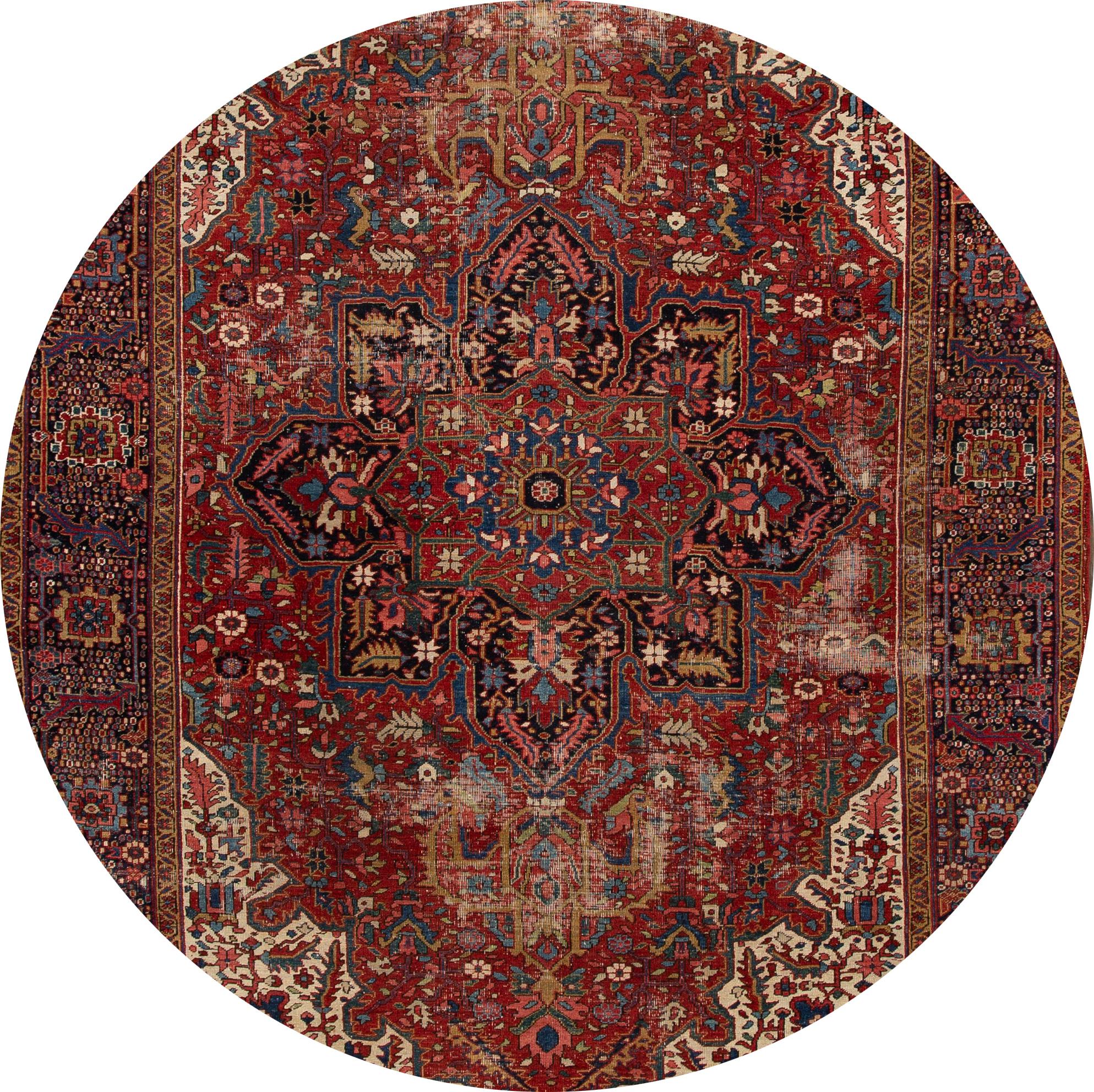 Beautiful hand knotted Persian Heriz wool rug. This rug has a rust field with multicolored accents featuring a traditional all-over design,

circa 1920

This rug measures 8' 7