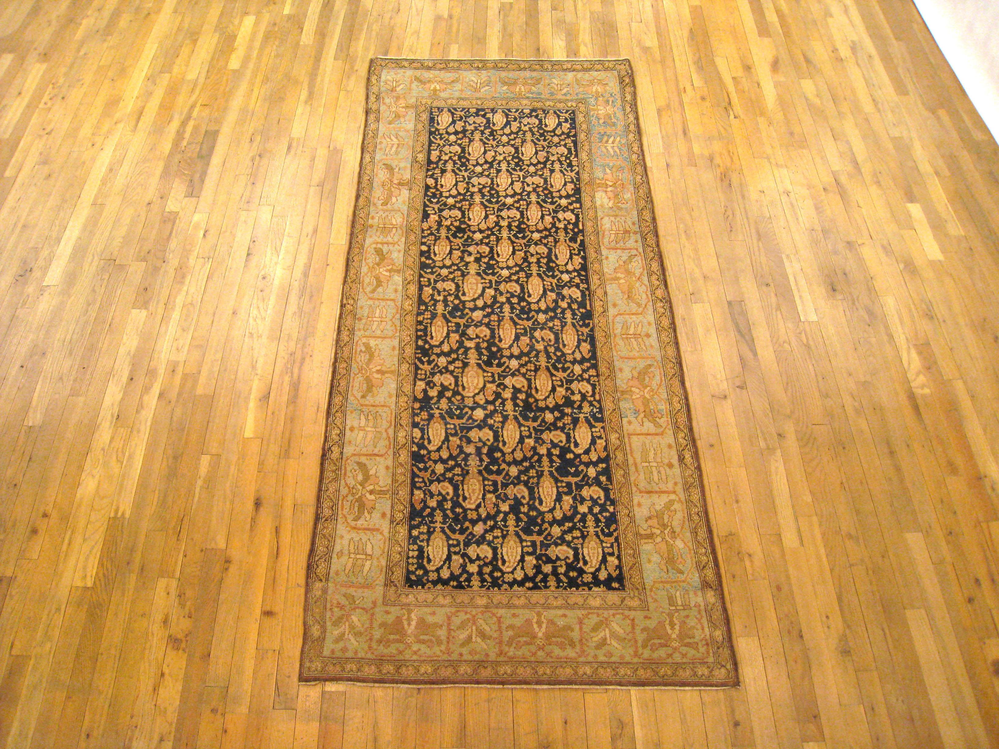 An antique Persian Malayer oriental rug in a small runner size, size 8'3