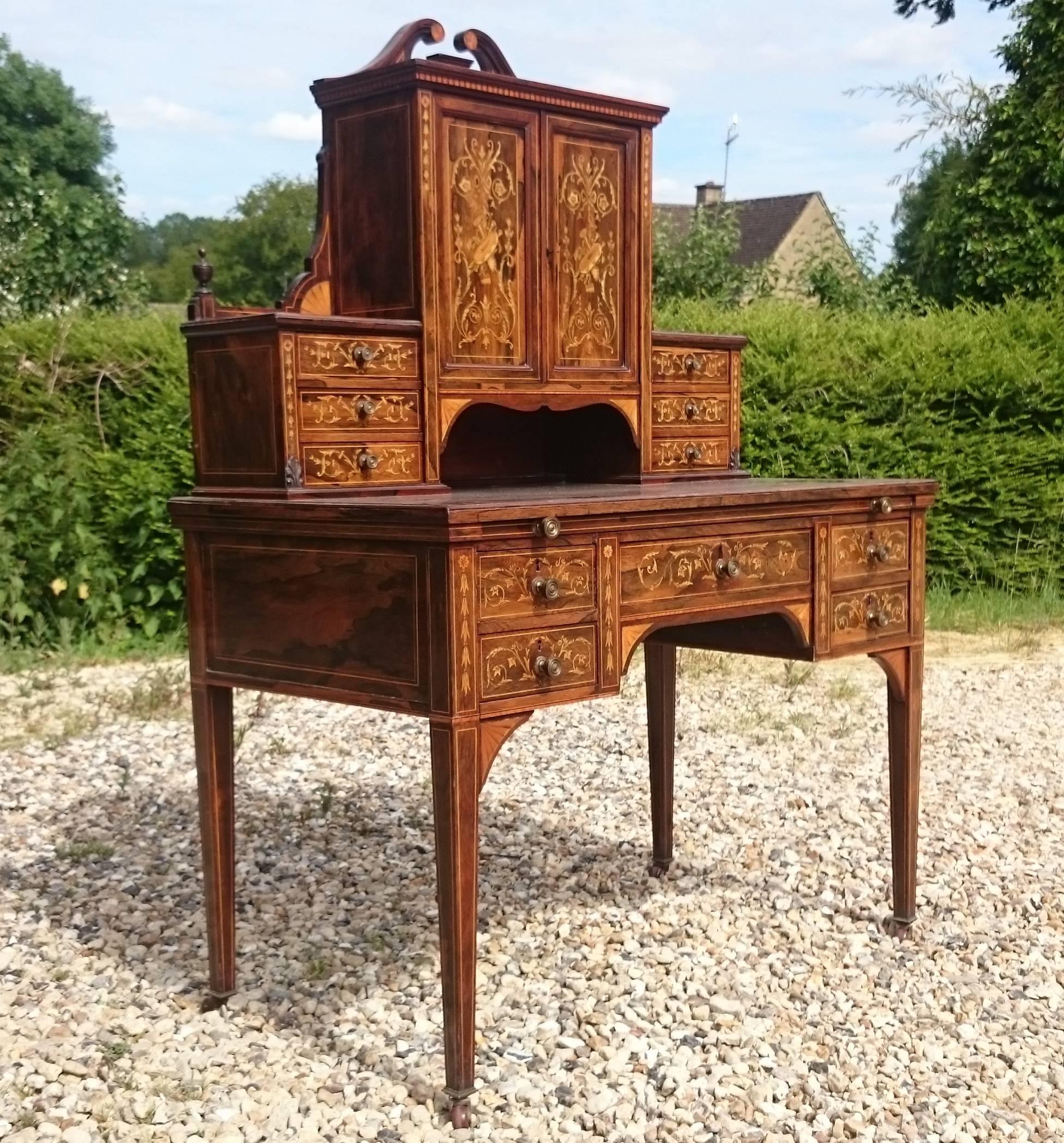 Early 20th century antique secretaire cabinet standing on square taper legs. This secretaire is a very fine example of this period of cabinet making. It is covered with finely inlaid boxwood decoration and the drawer linings are made from a good cut