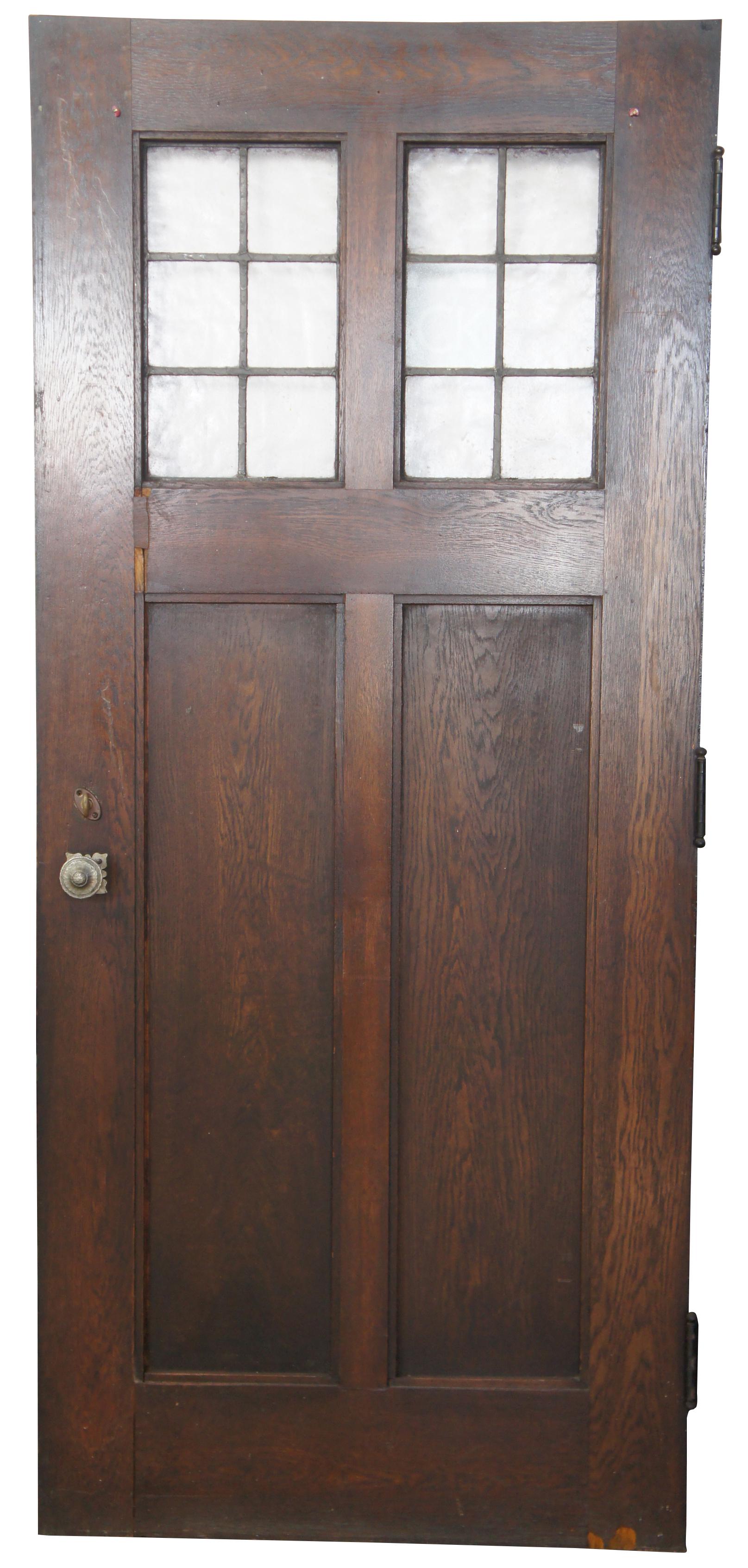 Early 20th century indoor outdoor paneled oak and leaded glass door. Features hammered brass hardware and deadbolt lock. Comes from one of the first homes built in oakwood, Ohio by Harry I Schenck, circa early 1900s. Measures: 36” x 81”.
  