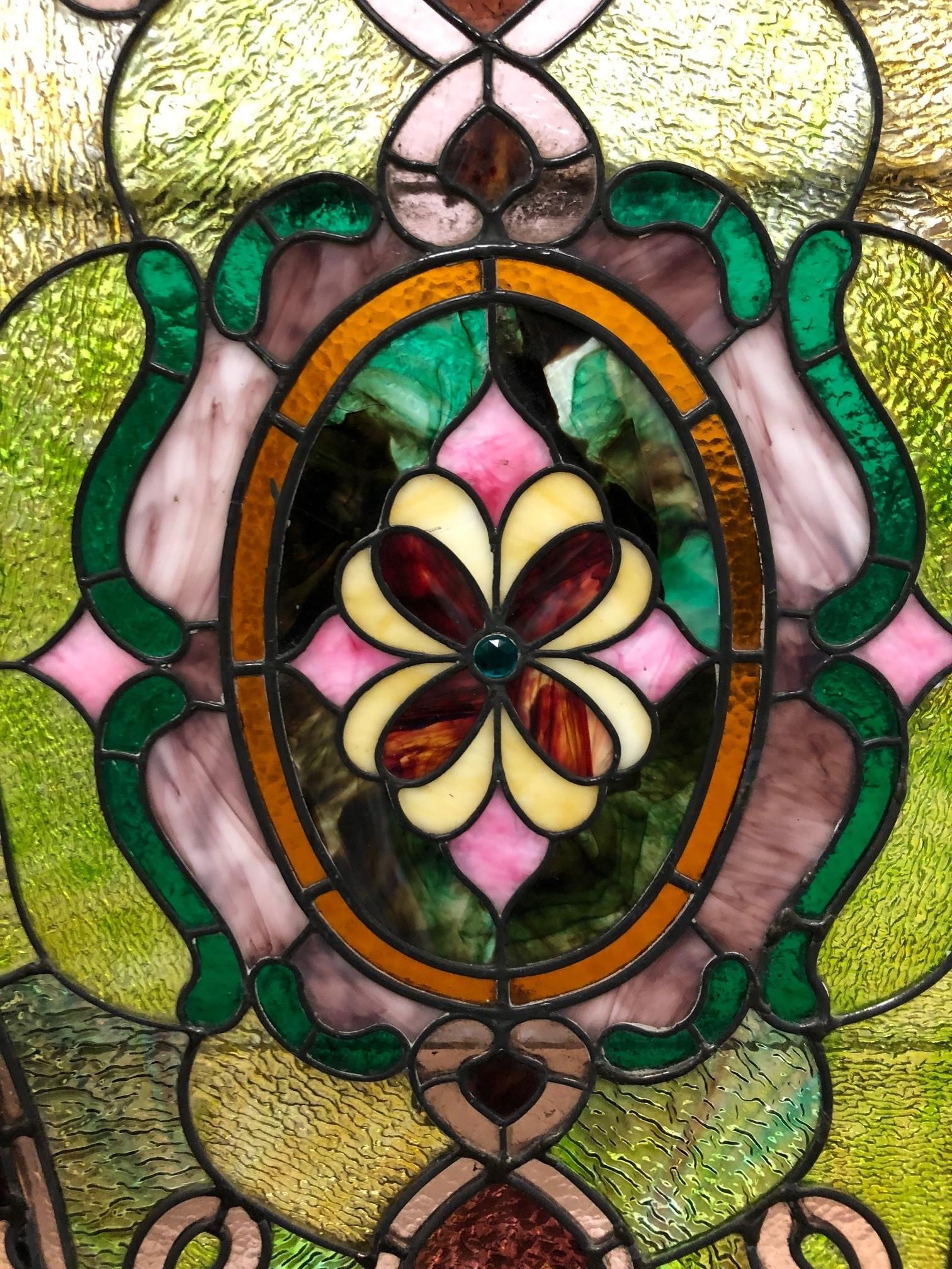 Early 20th century Stained glass window circa 1910 with beautiful pink and green colors. The colors look great in this window and with this pattern you can hang the window vertical or horizonal. It also could be used in a ceiling skylight. The frame