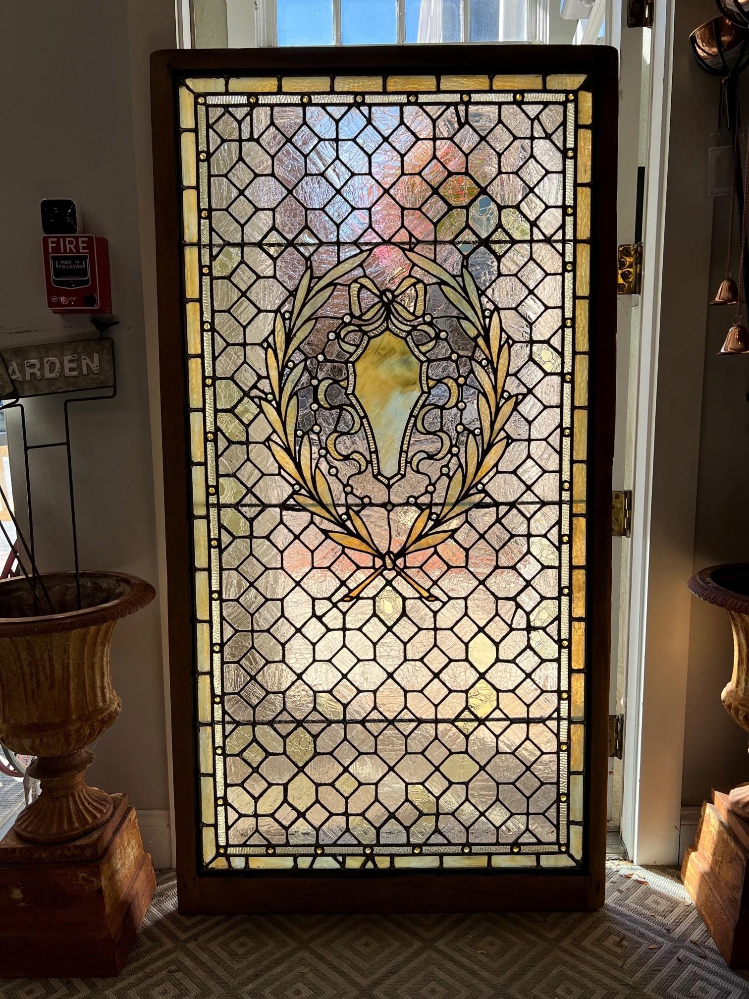 Early 20th century antique stained glass window from an New York estate. WOW this is an a amazing window with all the small pieces of crackle glass and small jewels with beautiful lead work its really amazing. The window just came back from the